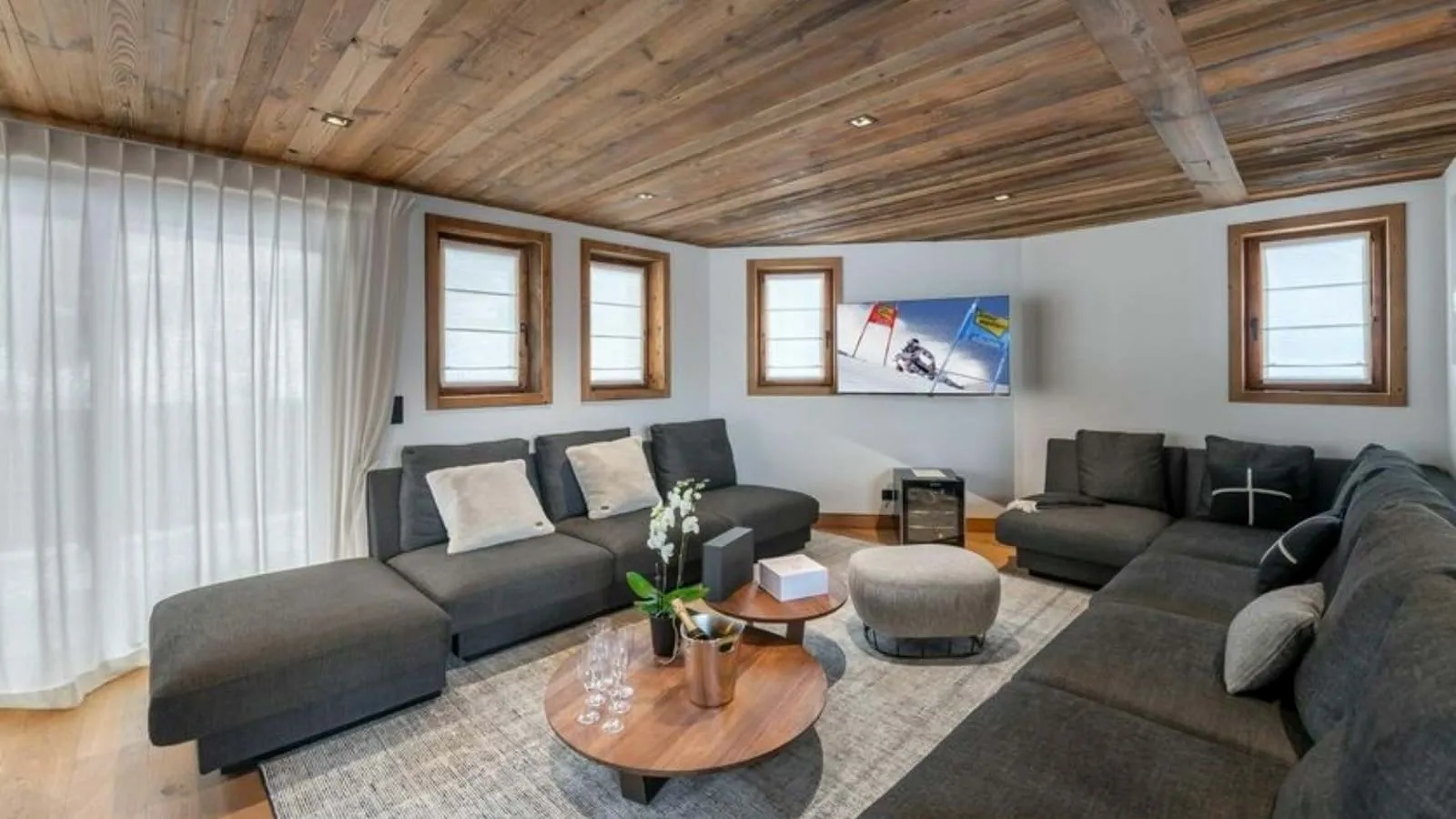 Television lounge with built-in cabinetry and upholstered seating