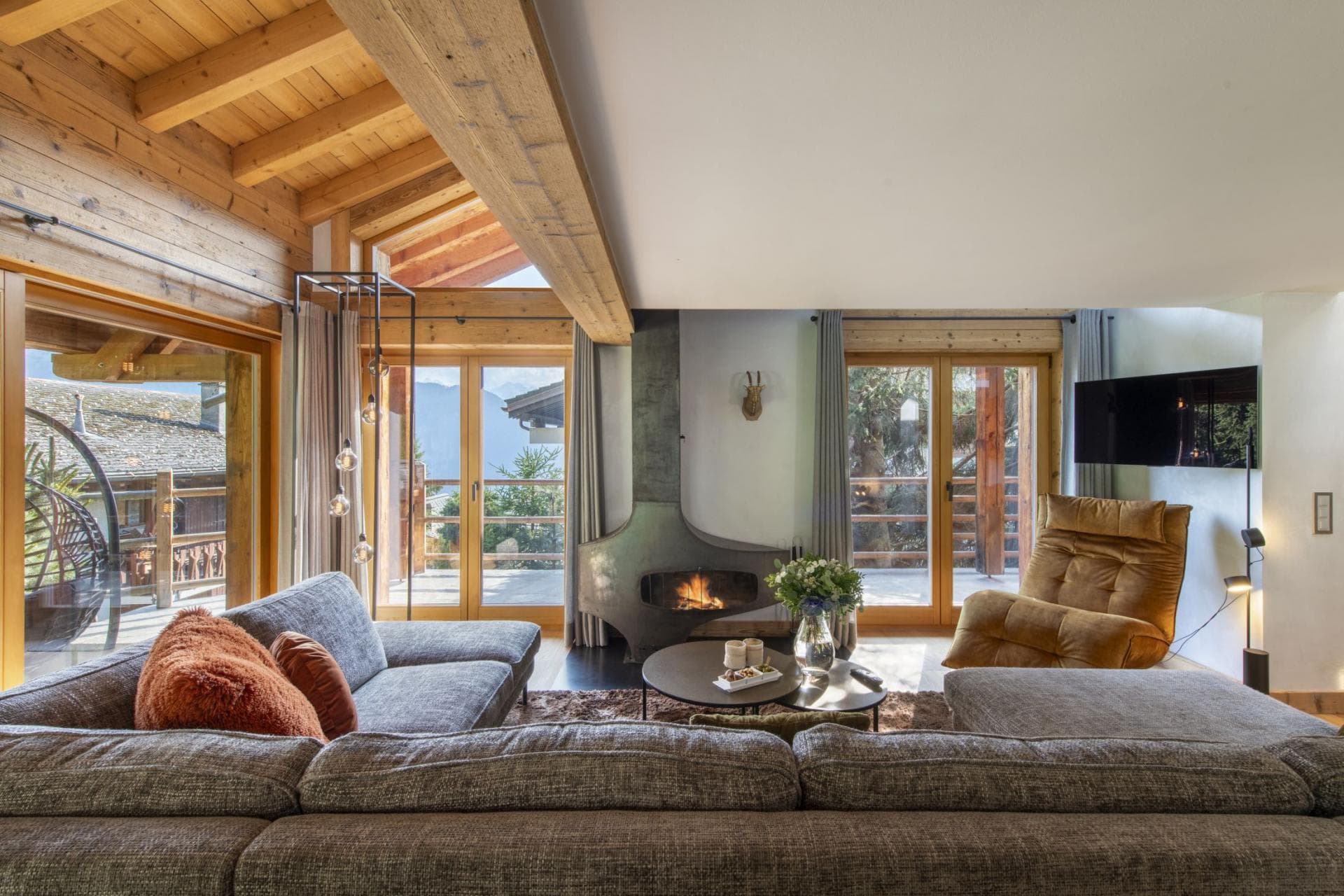 Living area with wood-burning fireplace and balcony access with mountain views