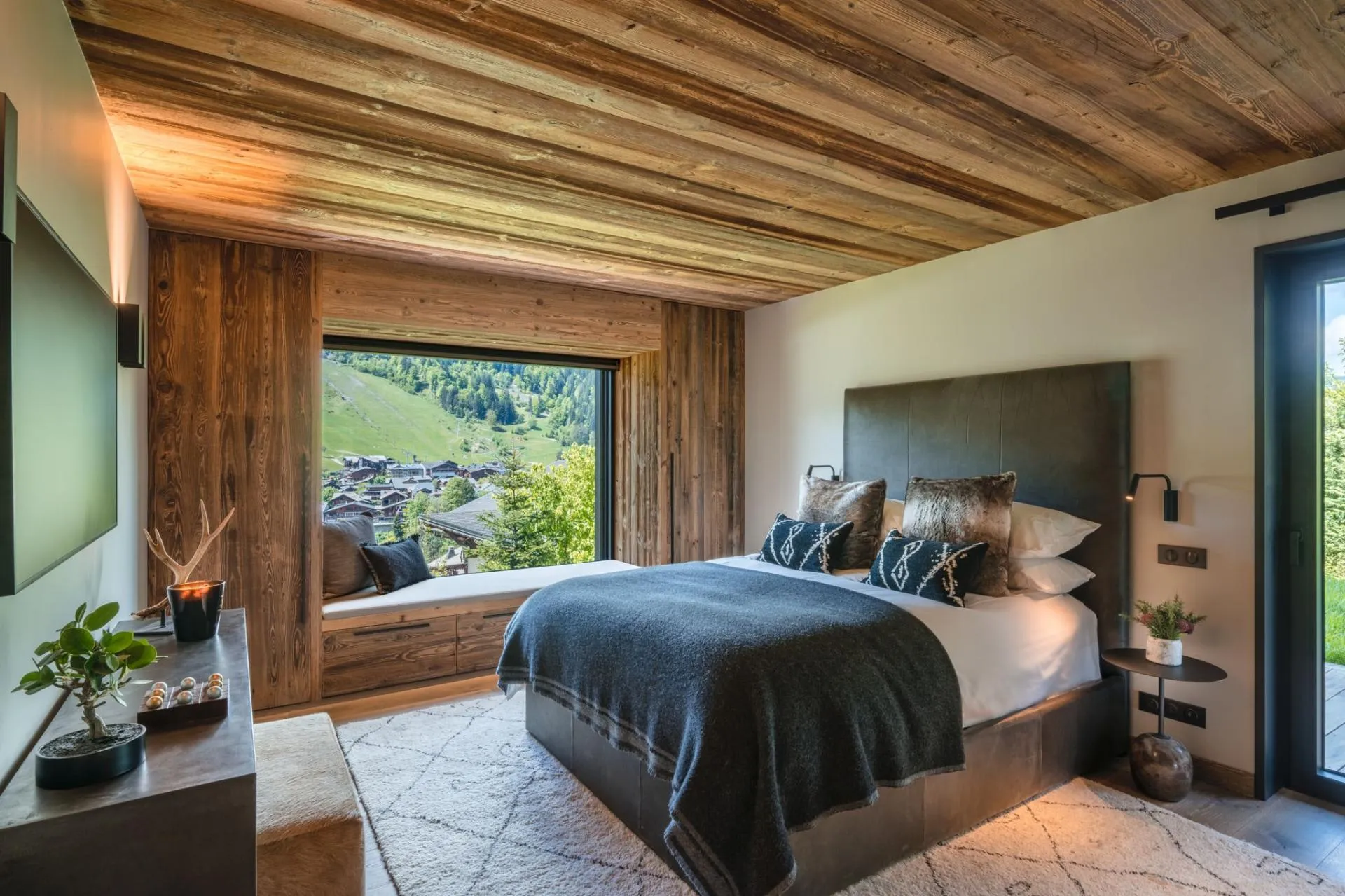 Queen bedroom with window seat and village views