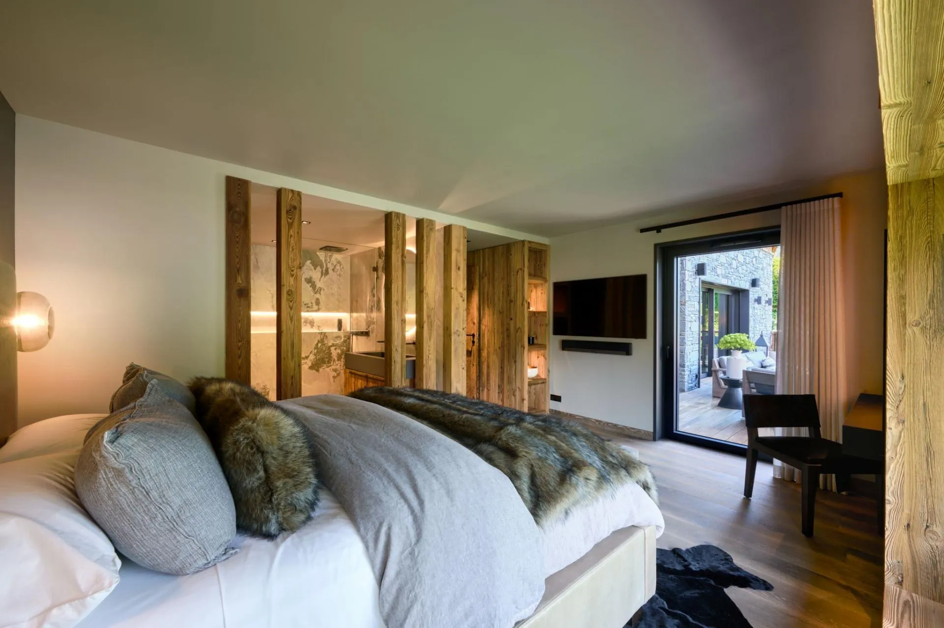 Primary bedroom with ensuite bathroom and sliding door to private deck