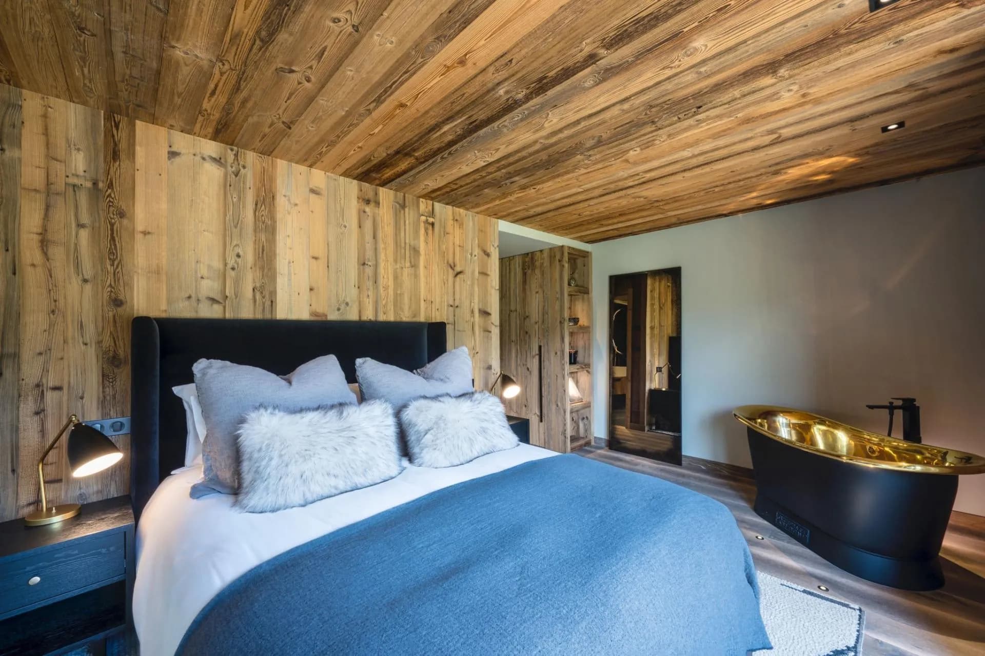 Queen bedroom with a freestanding copper bathtub and terrace access