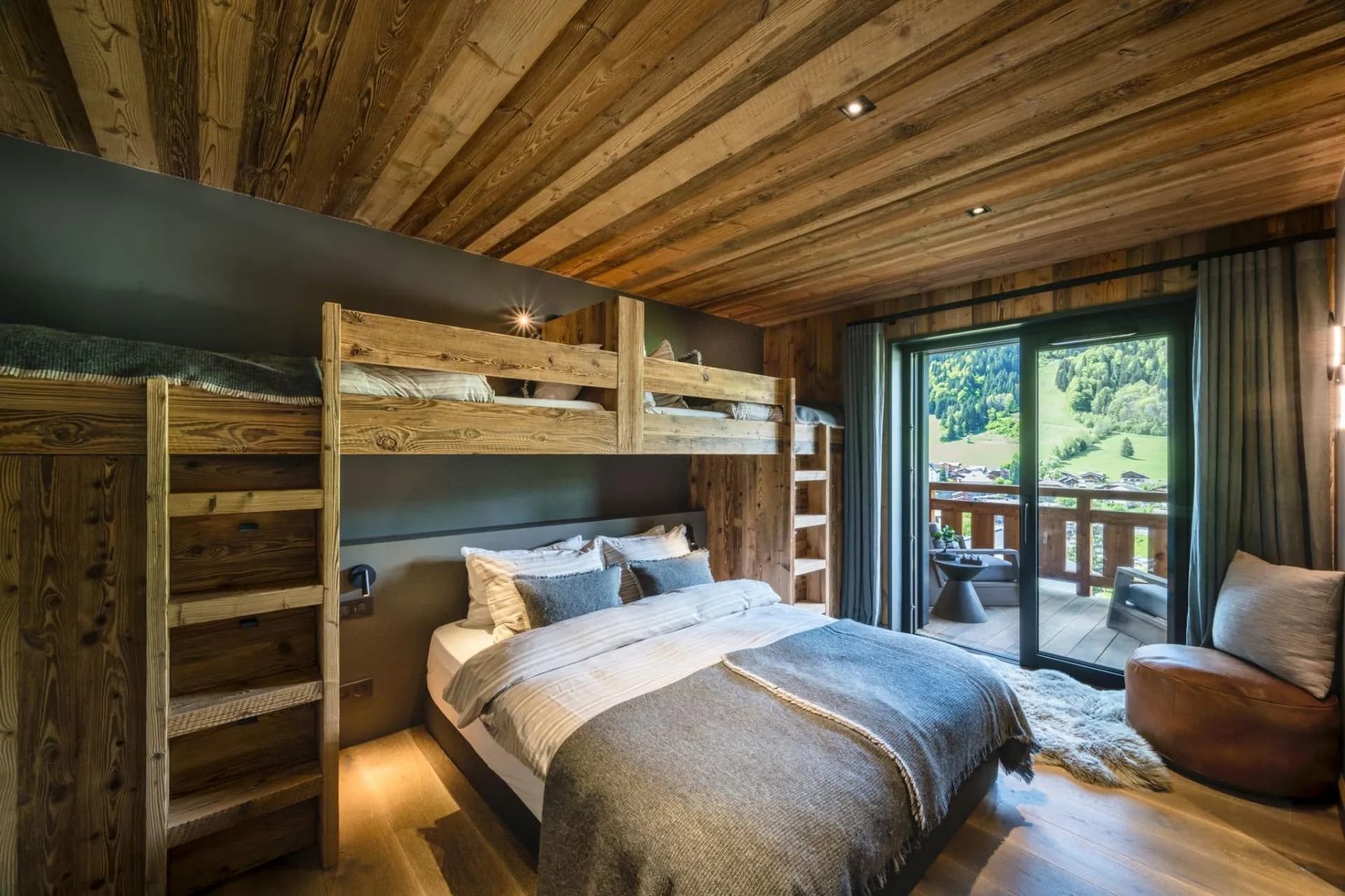 Family bedroom with a custom double bed, two full-size single bunks and terrace access