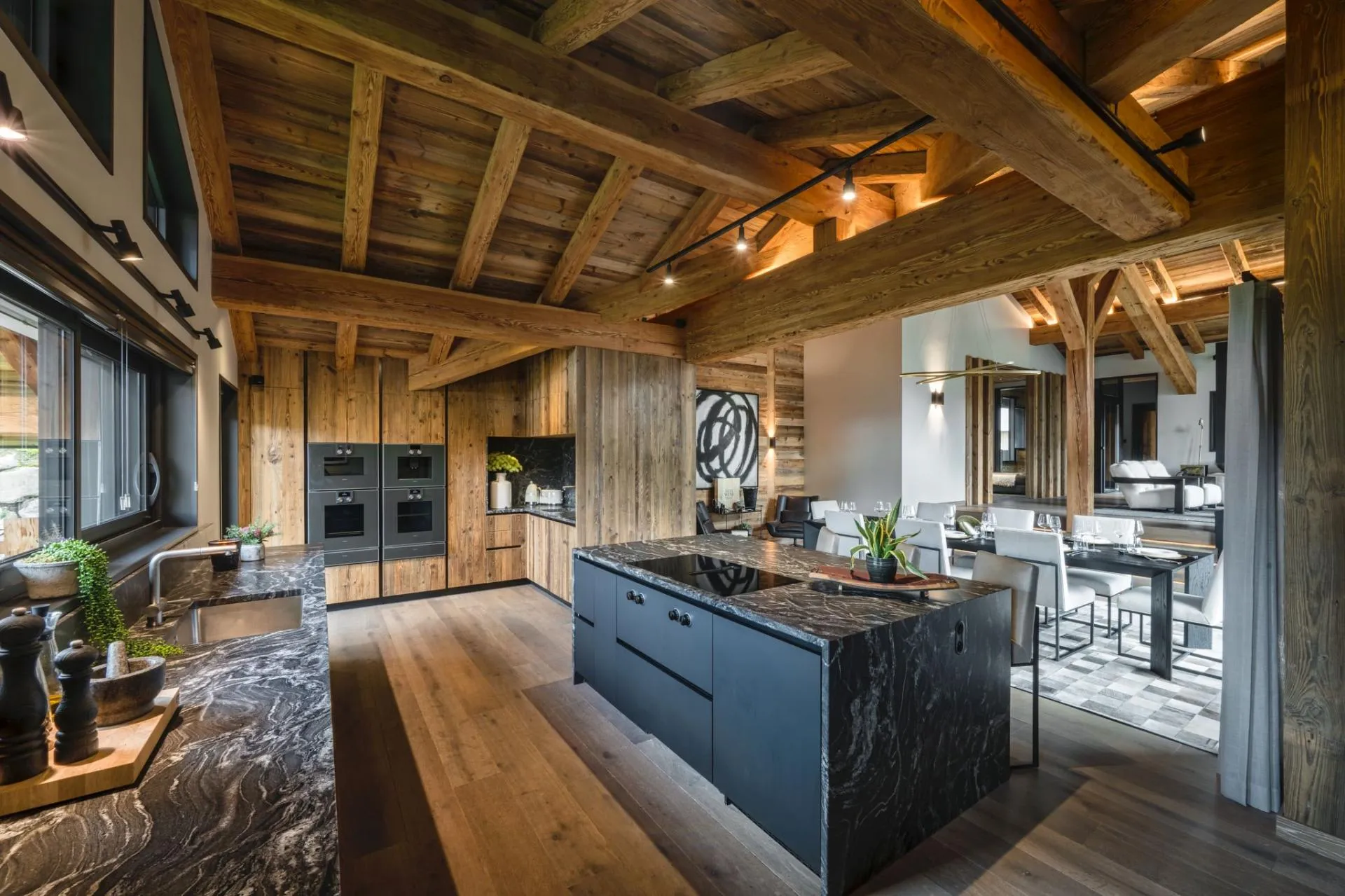Open-concept kitchen with dual wall ovens and island cooktop
