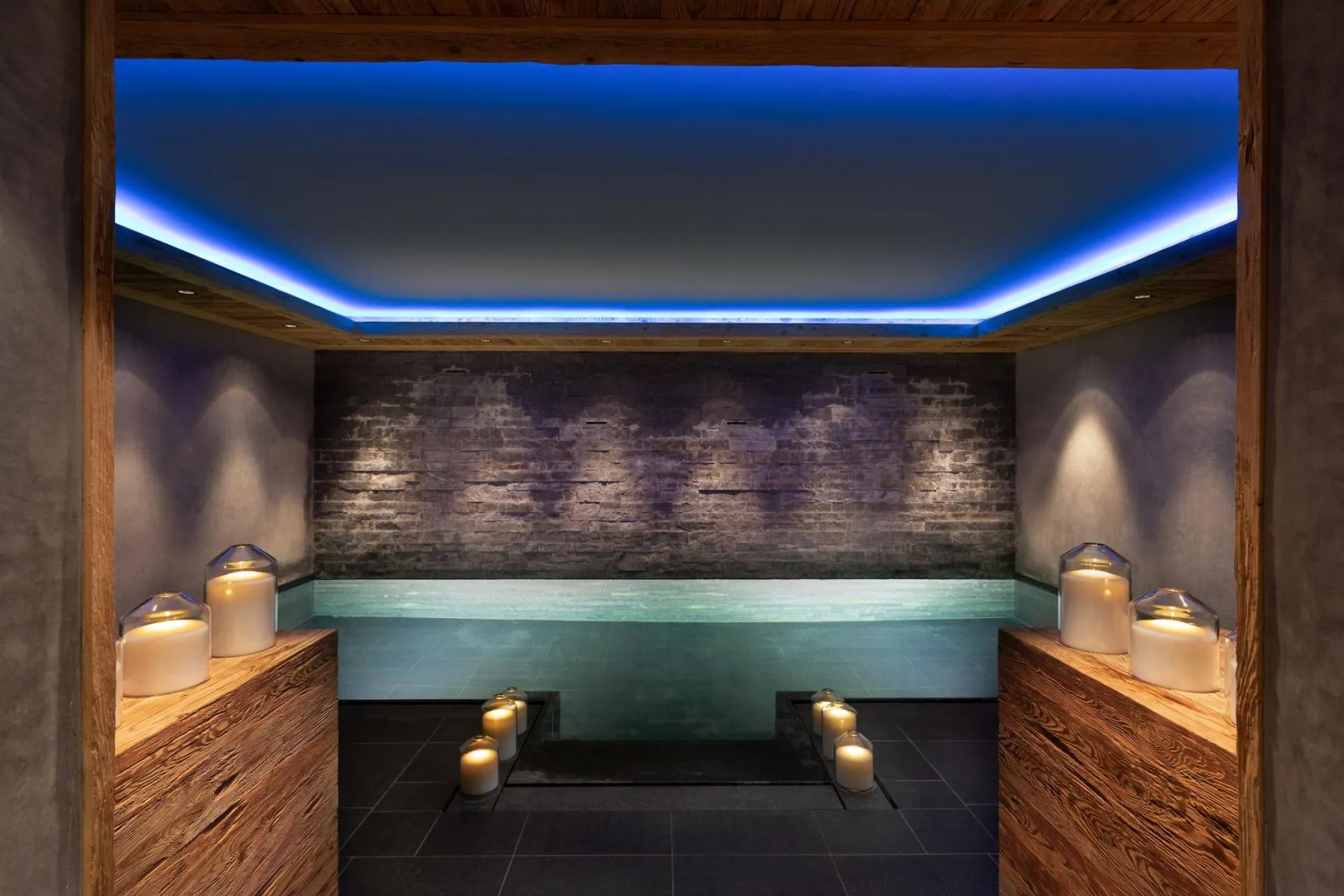 Indoor pool with stone feature wall and mood lighting