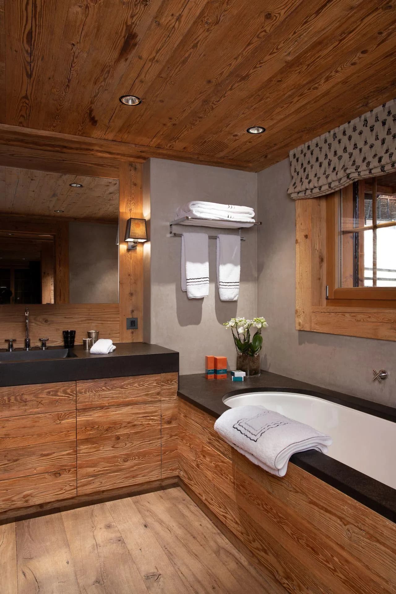 Bathroom featuring a deep soaking tub and rustic timber ceiling