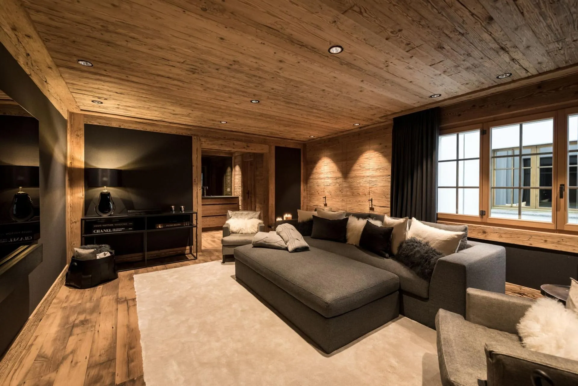 Media room with oversized sectional seating and reclaimed wood ceilings