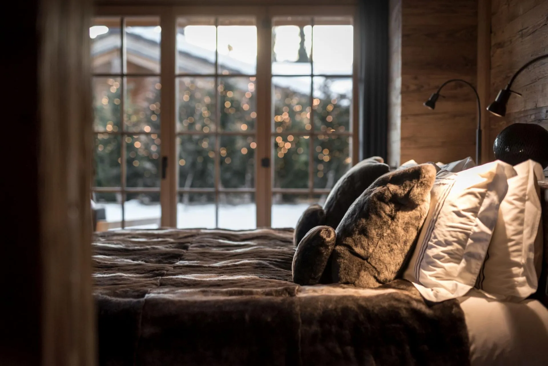 Bedroom with terrace access and reading lights; winter garden views