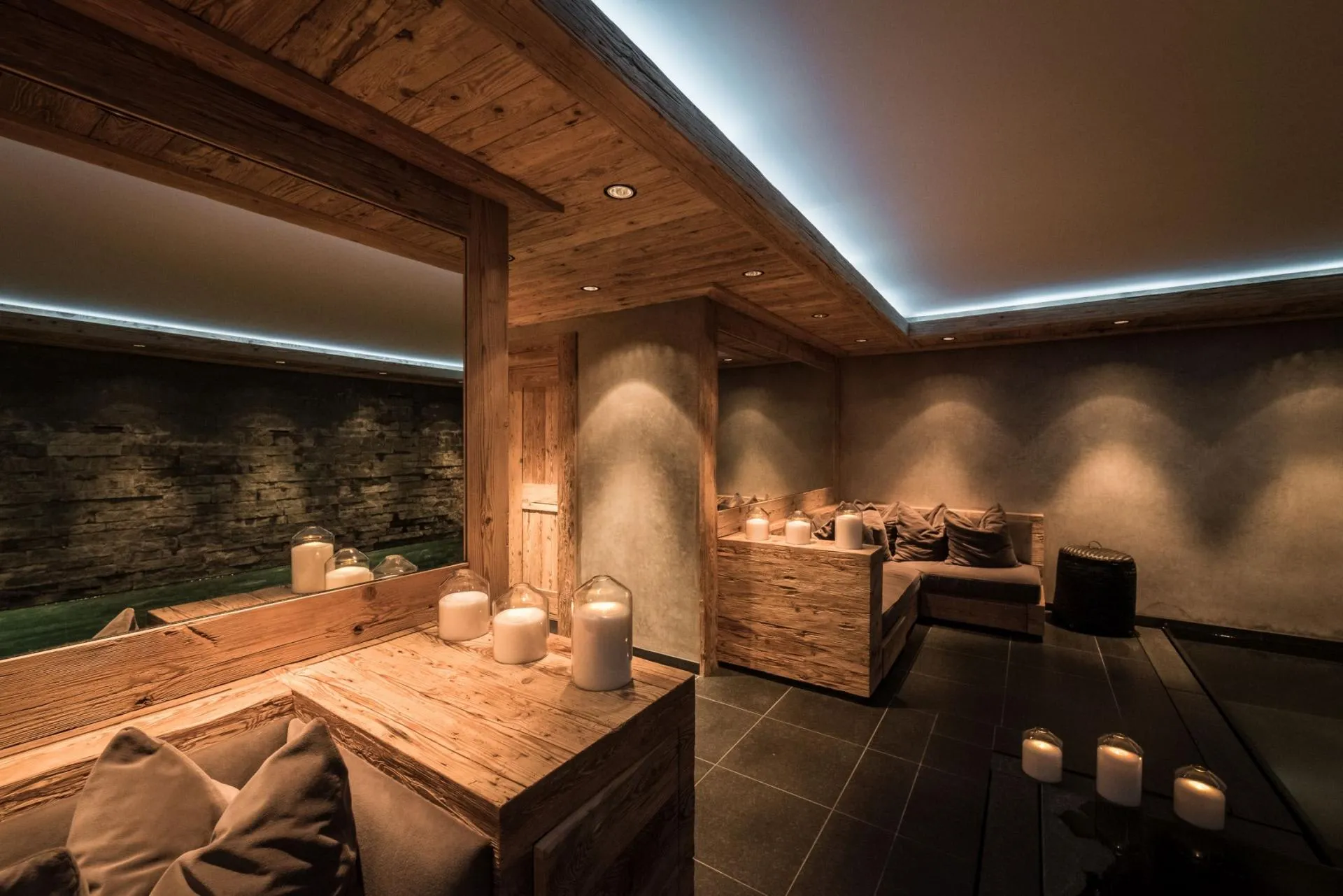 Spa lounge area with wood-paneled ceiling and indoor pool view