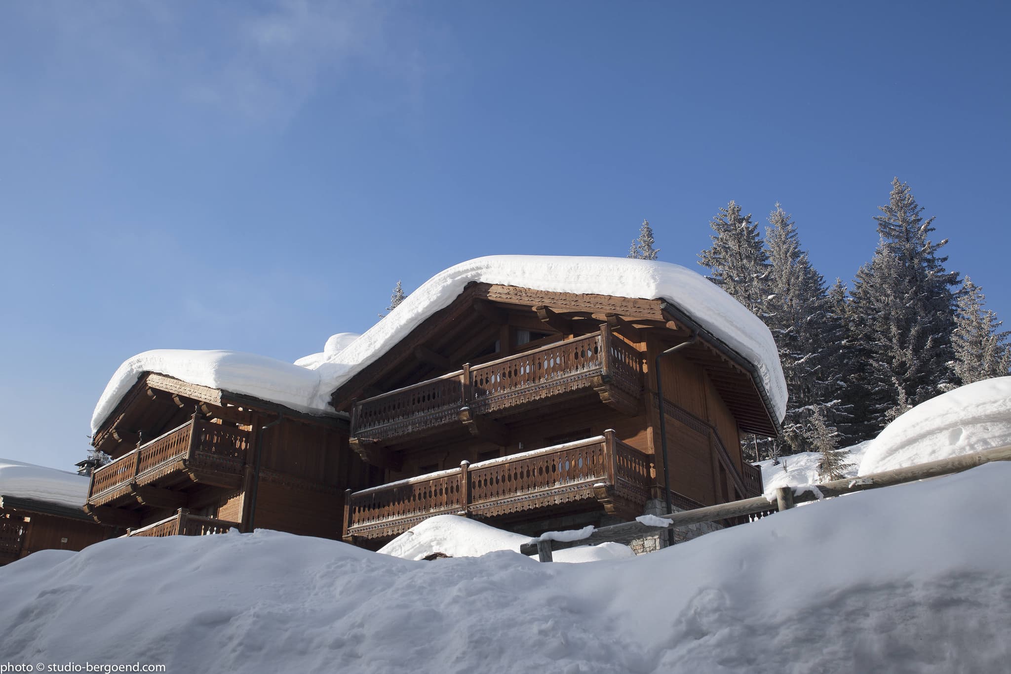 Ski-in chalet exterior with two levels of private wrap-around balconies