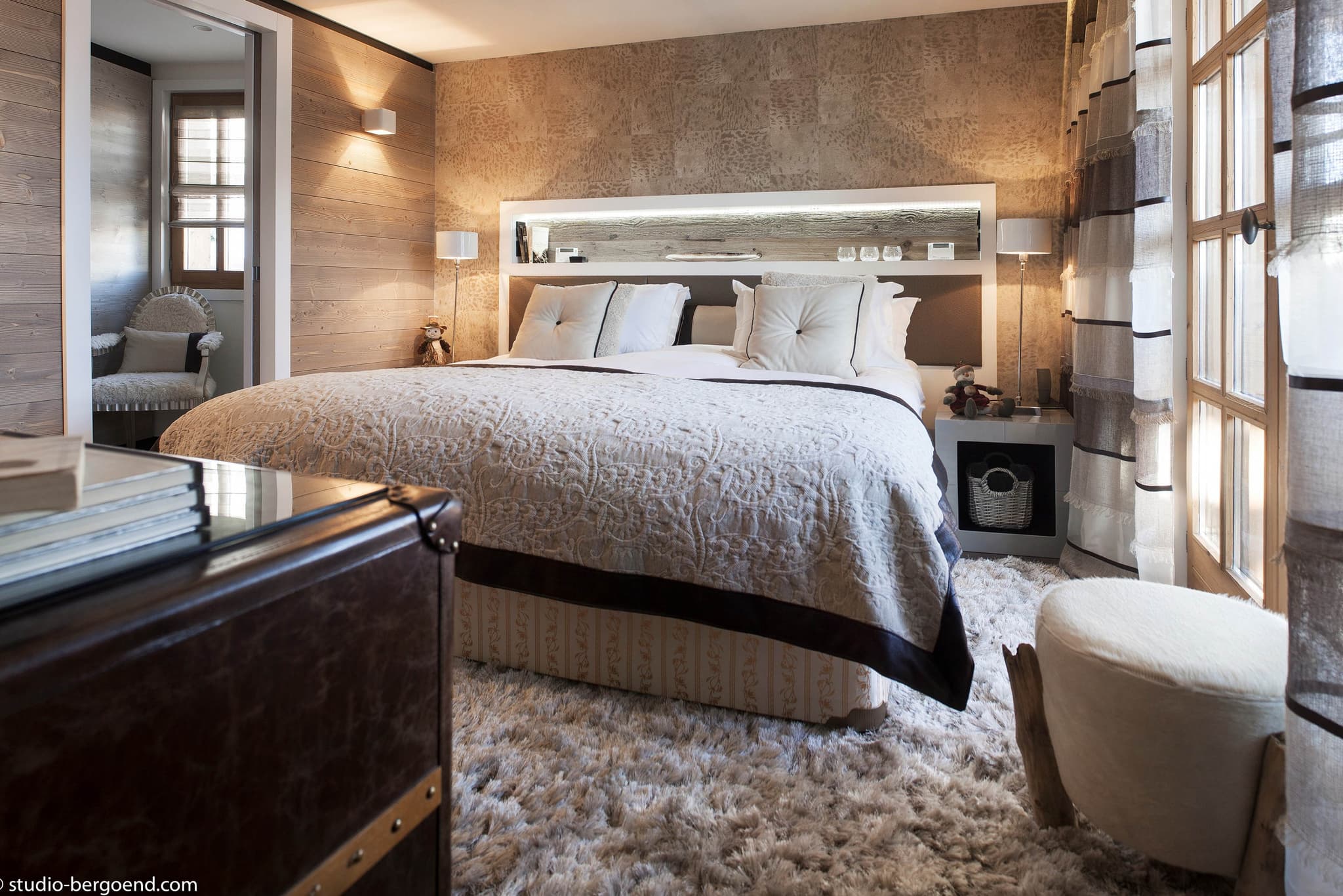 Primary bedroom with king bed and built-in headboard shelving