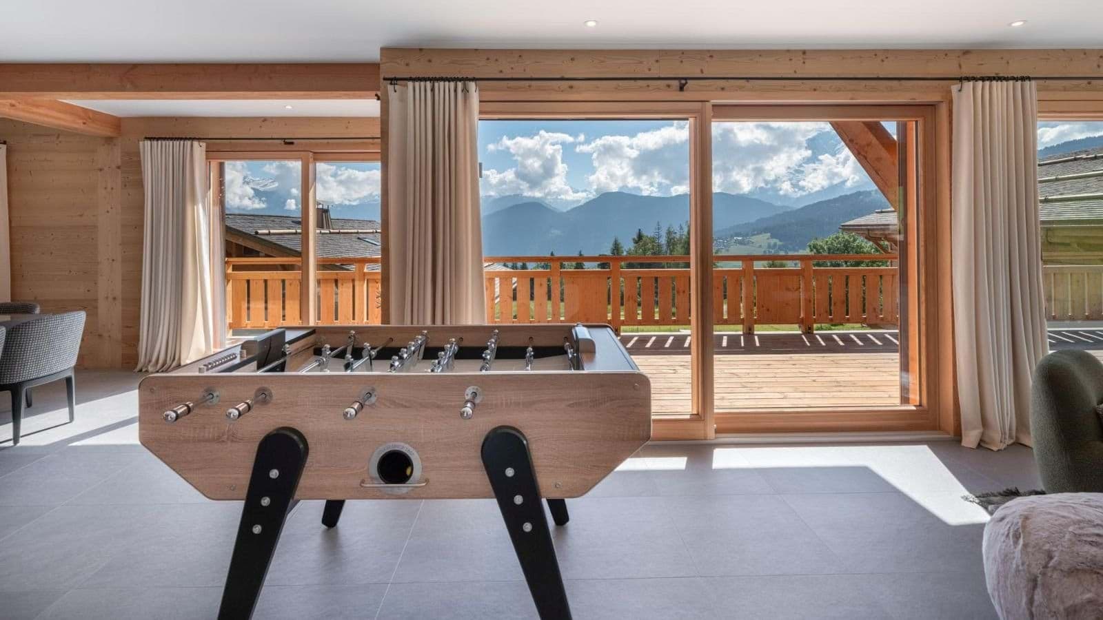 Game room with foosball table and balcony access to mountain views