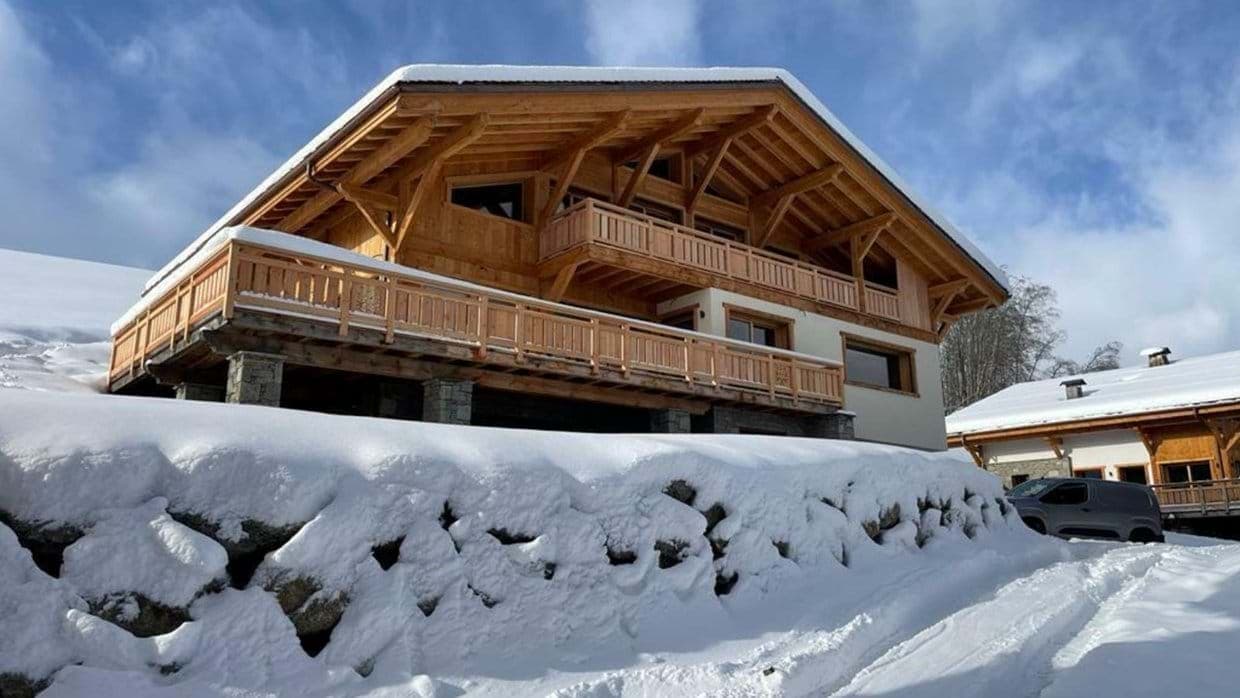 Ski-in chalets with multi-level timber balconies and mountain access