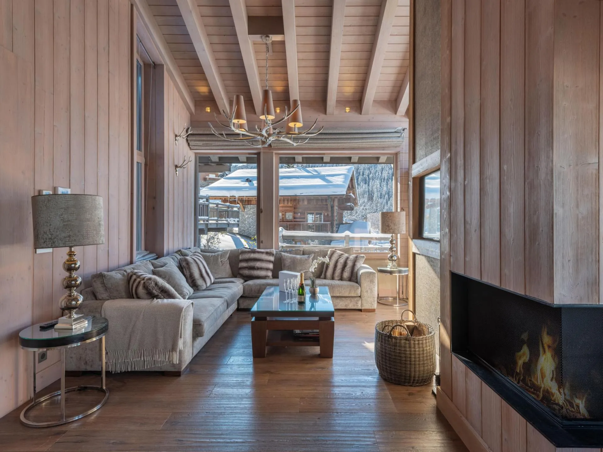 Living area with a corner wood-burning fireplace and sectional seating