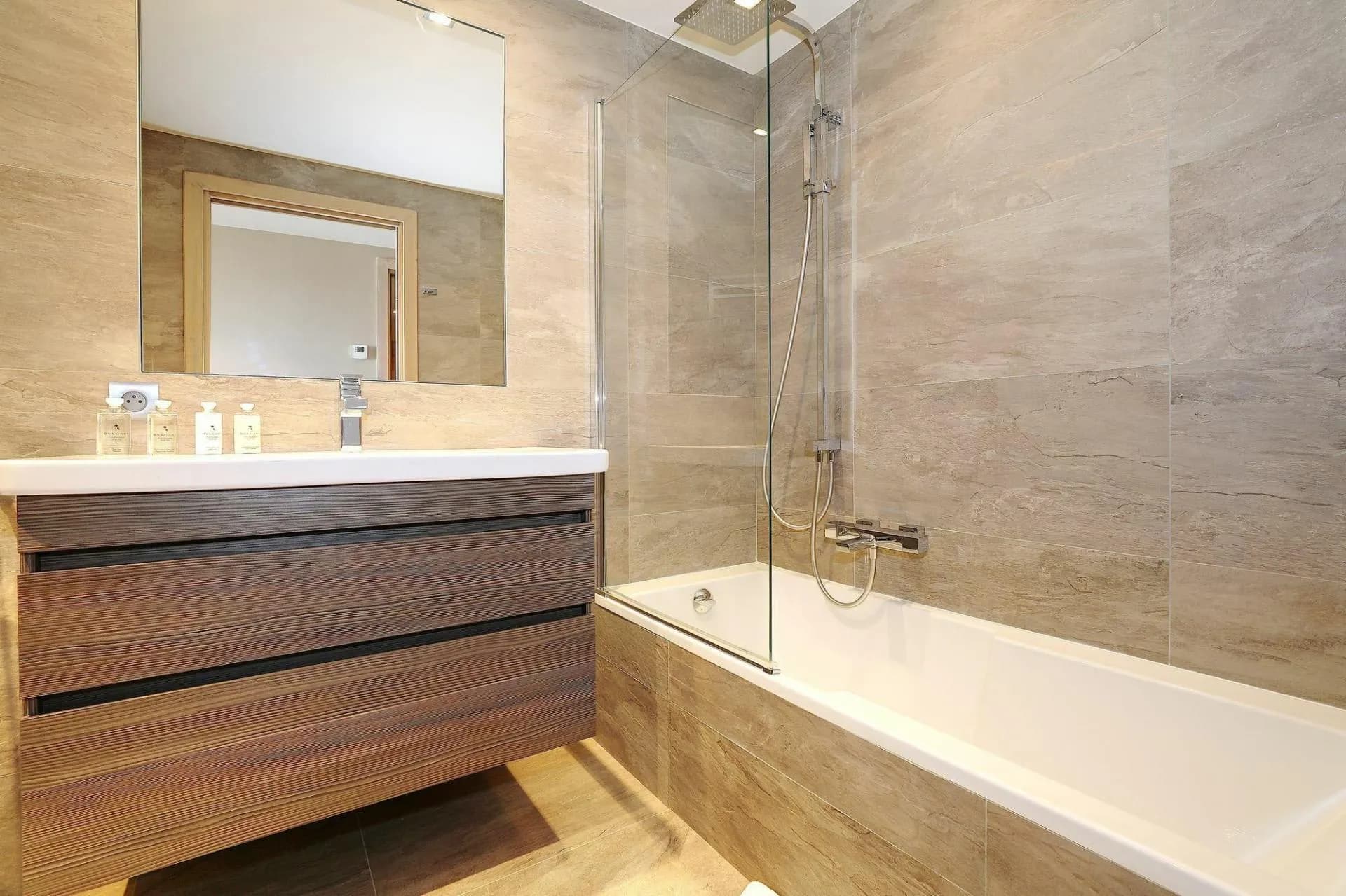 En-suite bathroom with a bathtub and glass shower screen