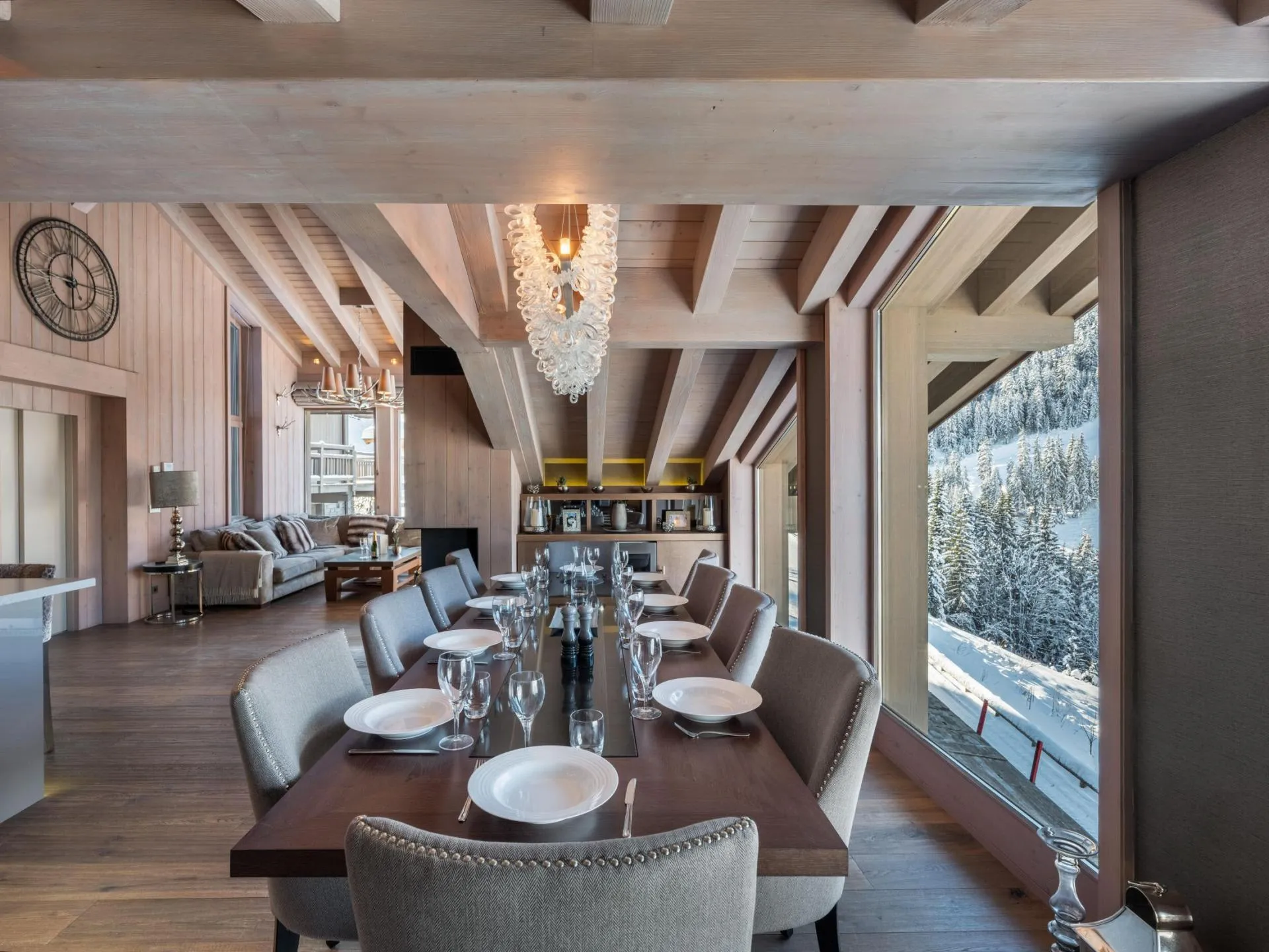 Dining area with broad windows overlooking snowy mountains