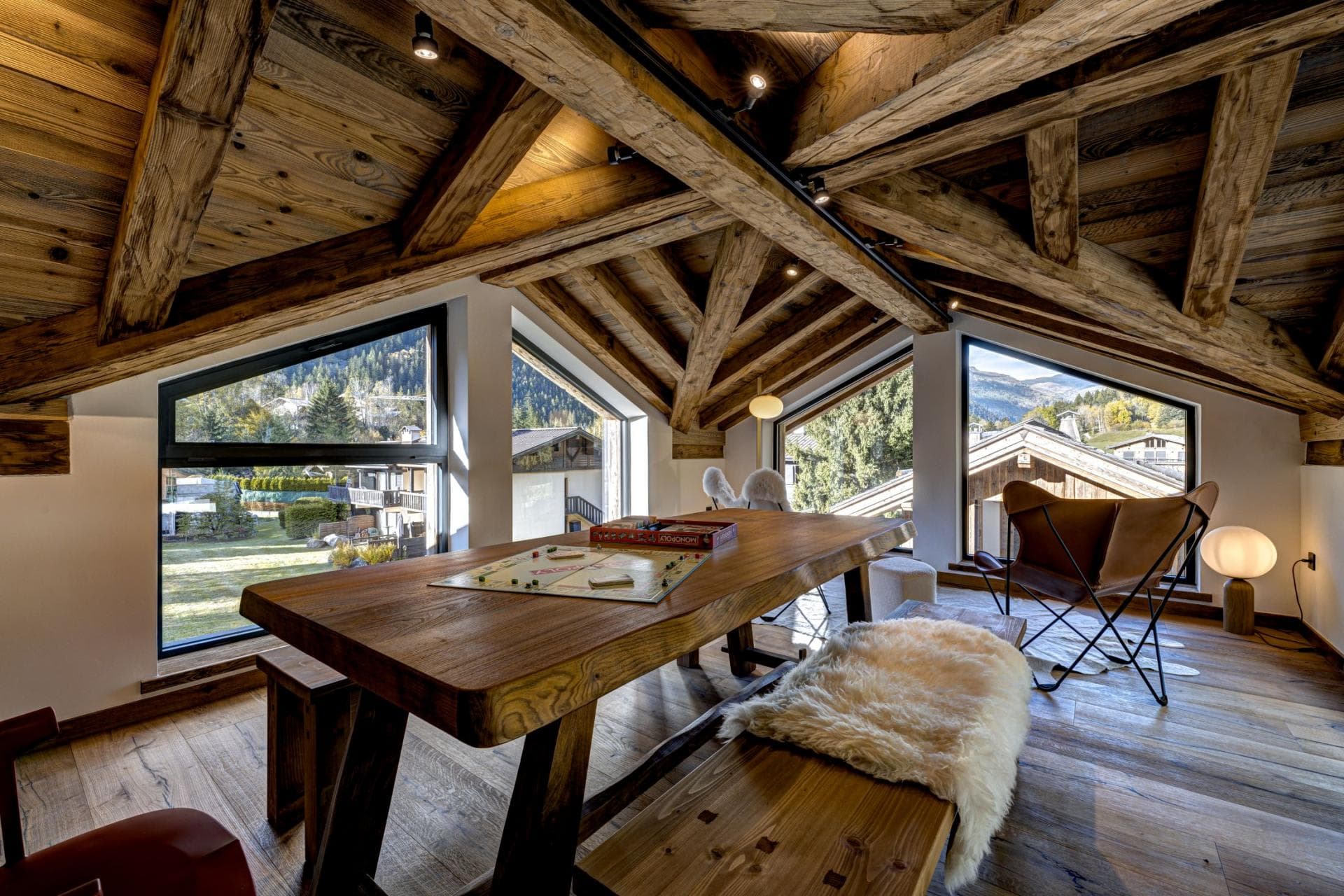 Loft games area with vaulted timber ceilings and village views