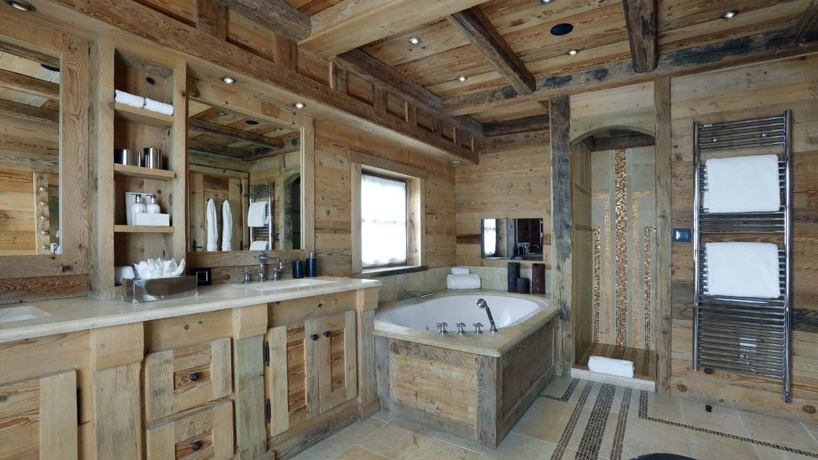 Bathroom with dual vanity, soaking tub, and heated towel rack