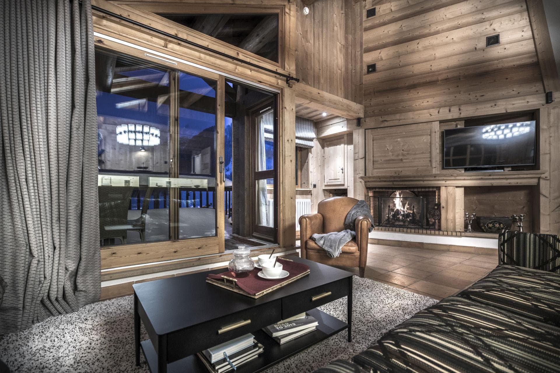 Living area with wood-burning fireplace and sliding door deck access