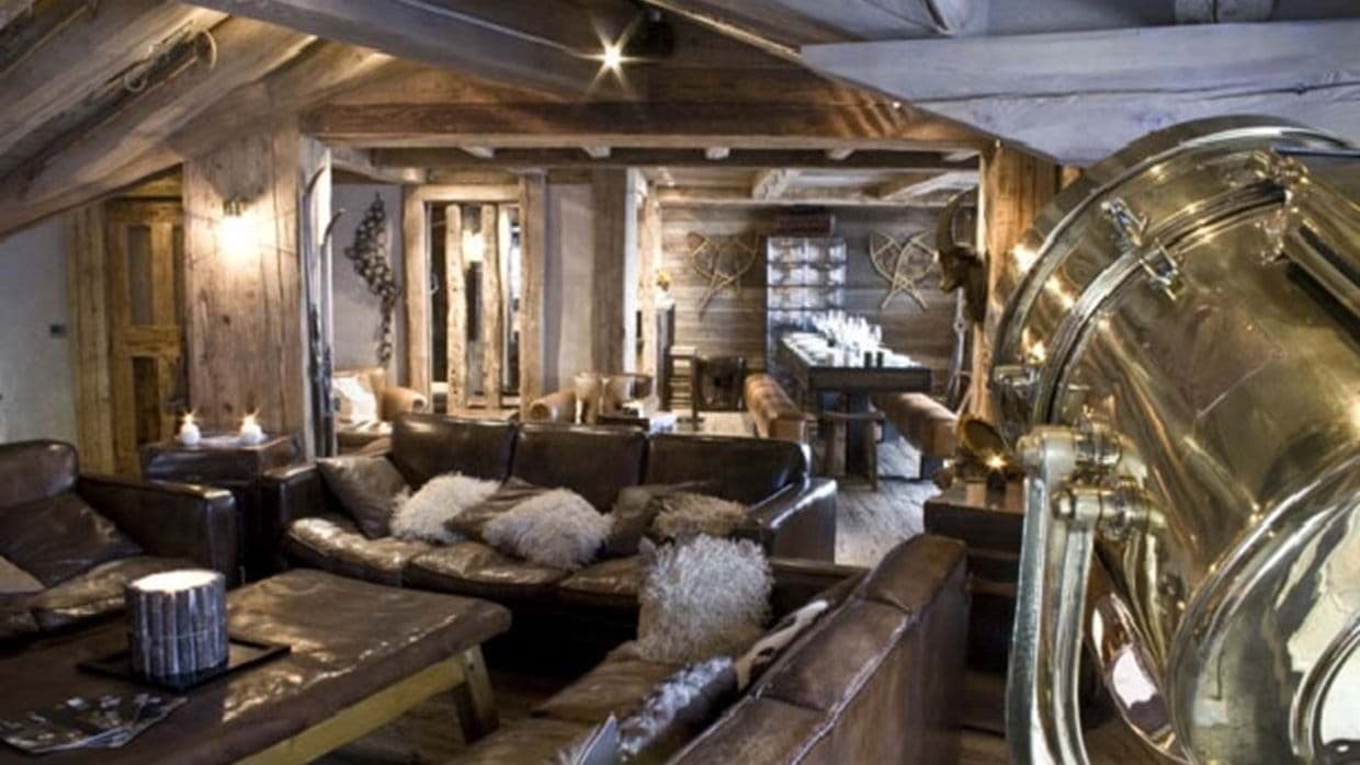 Open living and dining area with leather seating and long banquet table