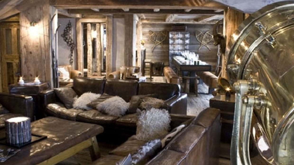 Open-concept living and dining area with reclaimed wood and seating for 10