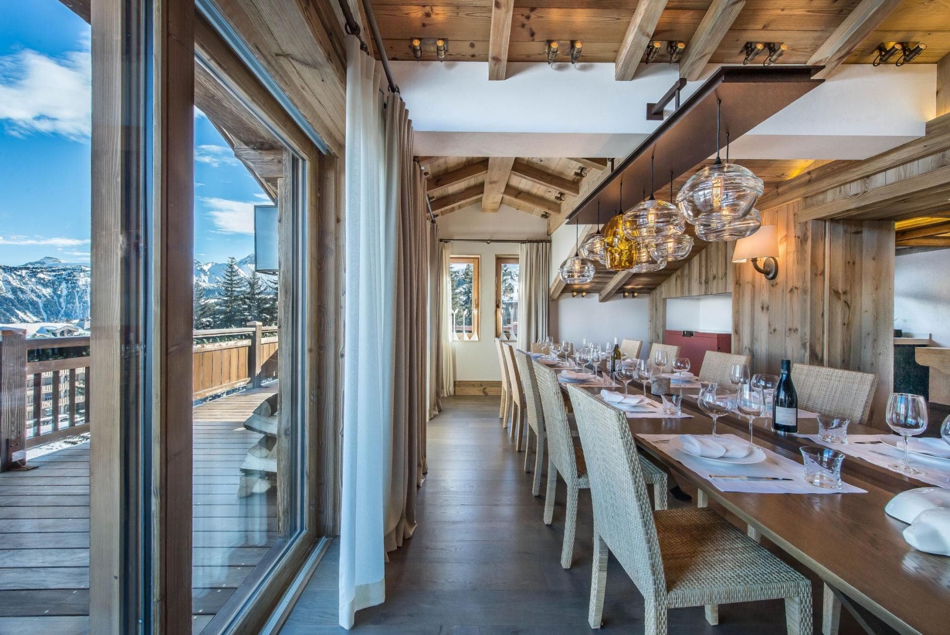 Dining room seats 8; alpine mountain views through floor-to-ceiling windows
