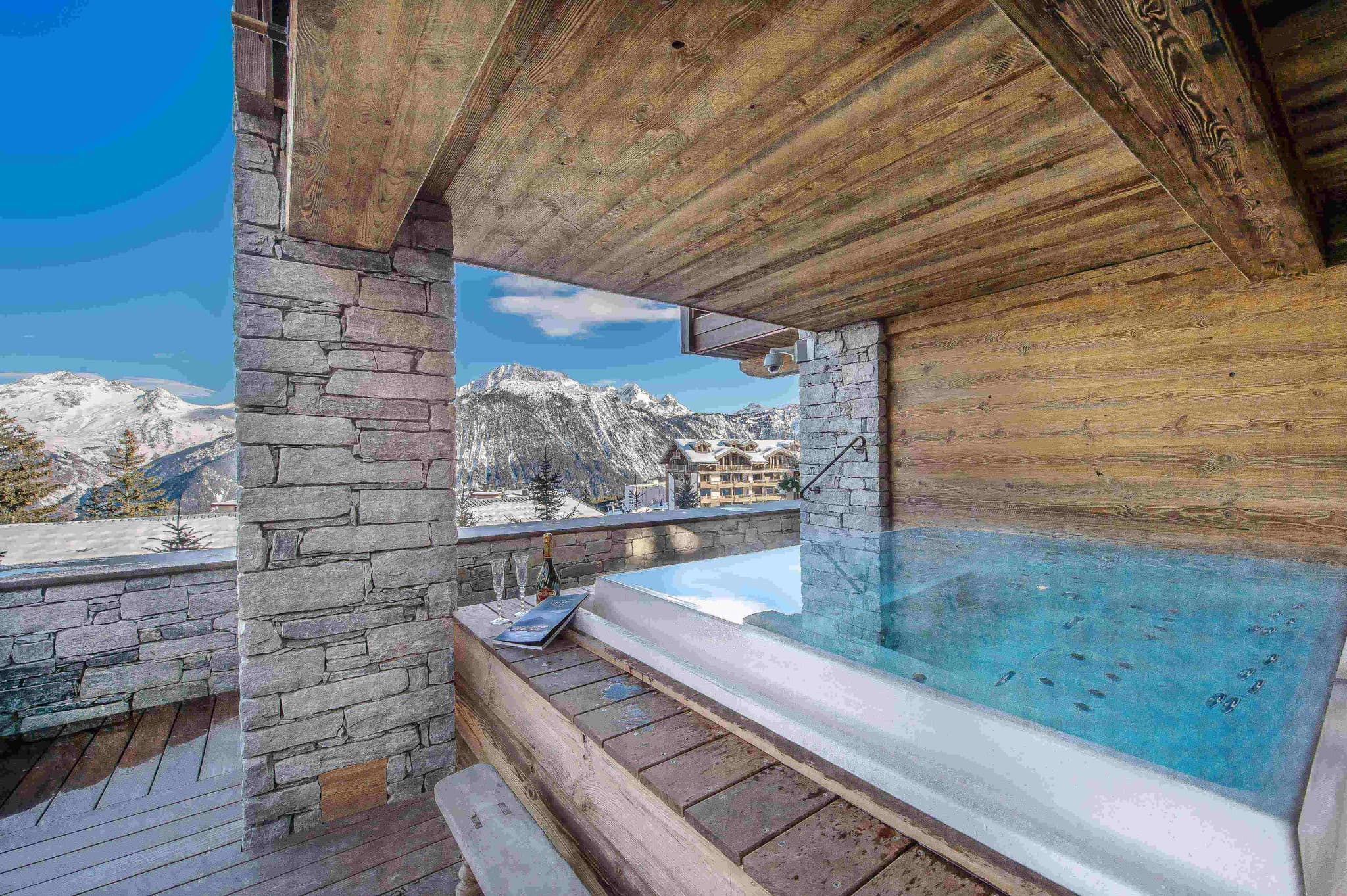 Covered outdoor hot tub with panoramic snow-capped mountain views