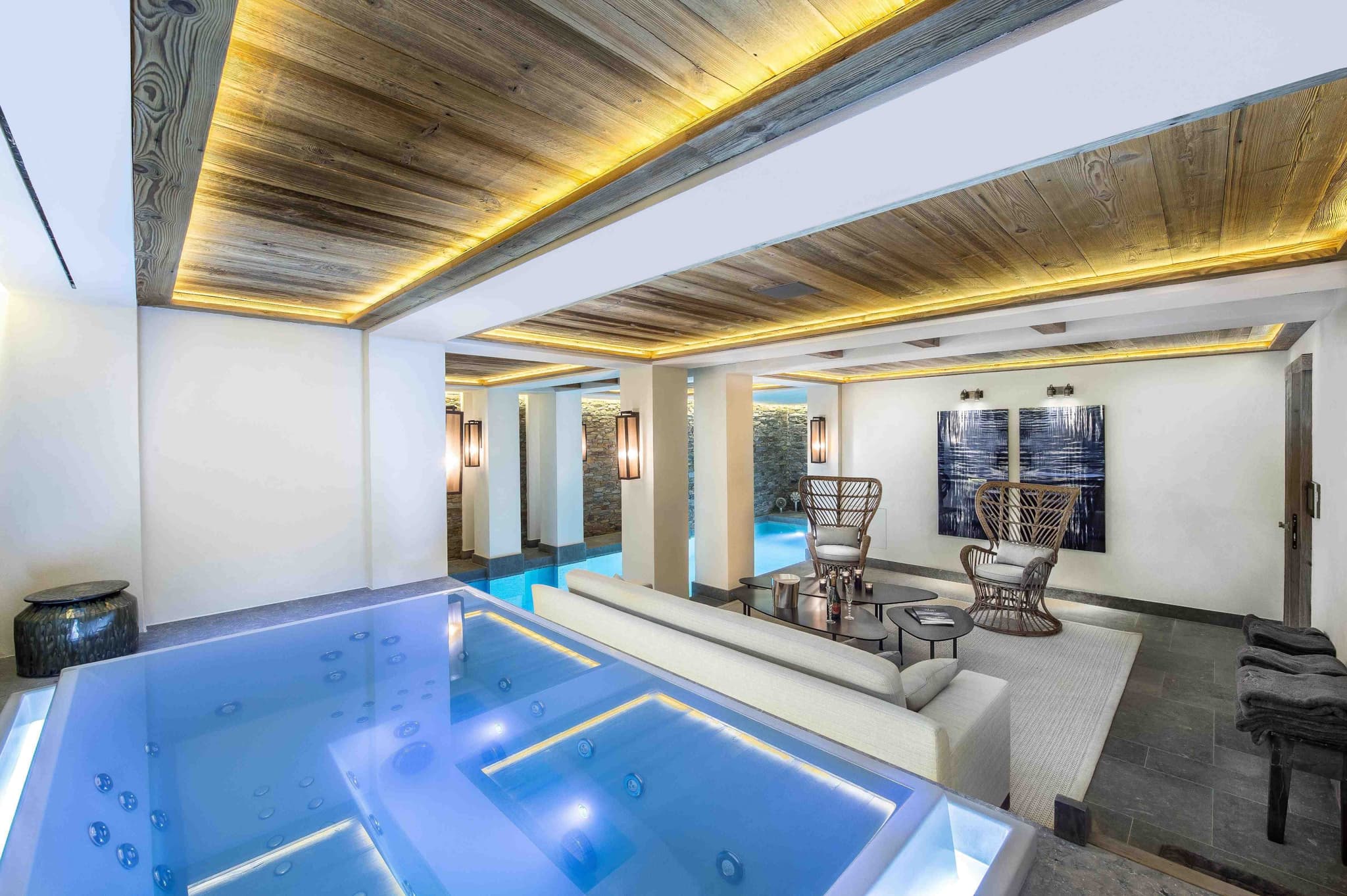 Indoor spa area with heated pool, hot tub, and lounge seating