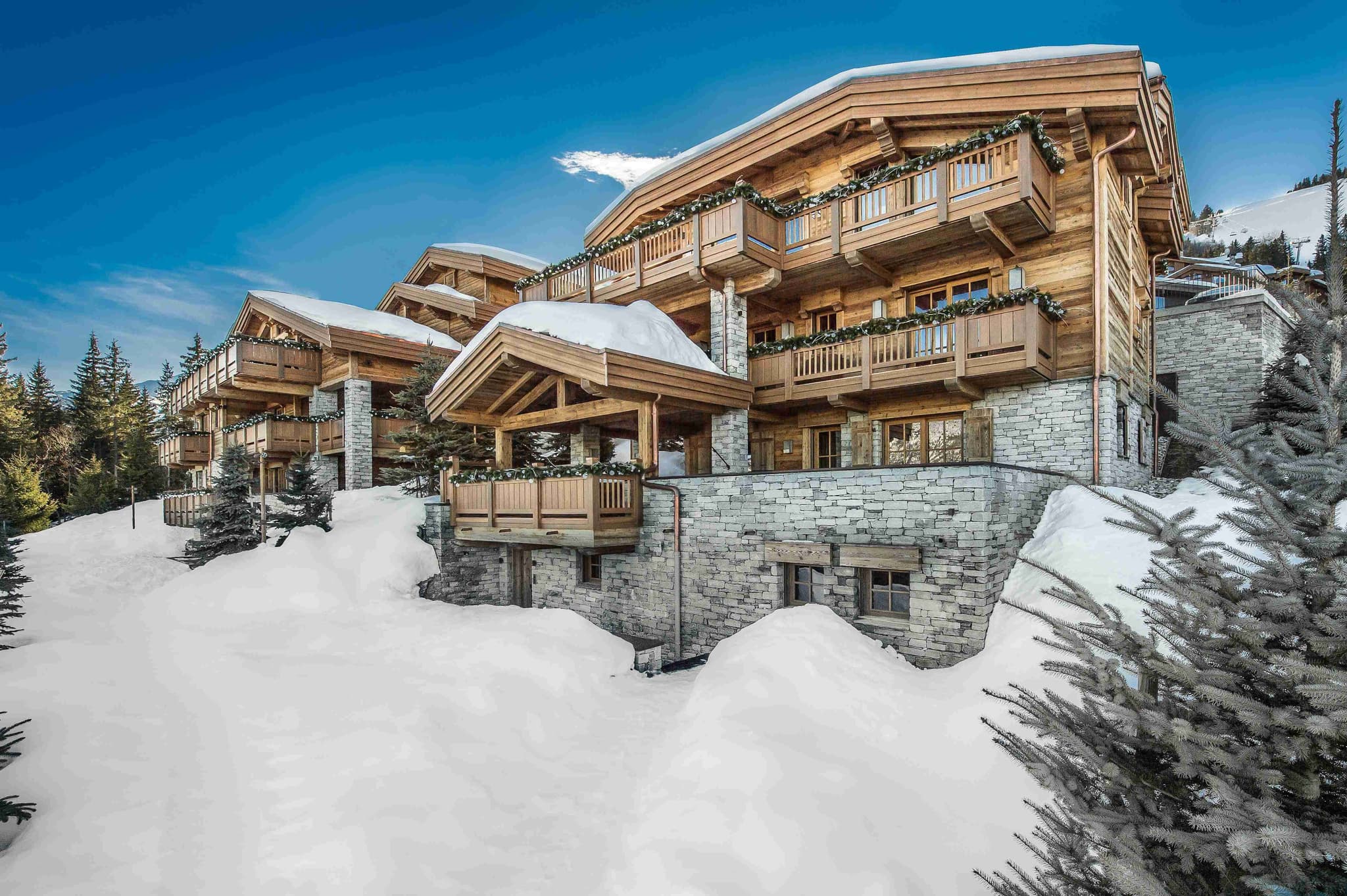 Ski-in/ski-out chalet with private balconies and stone masonry exterior