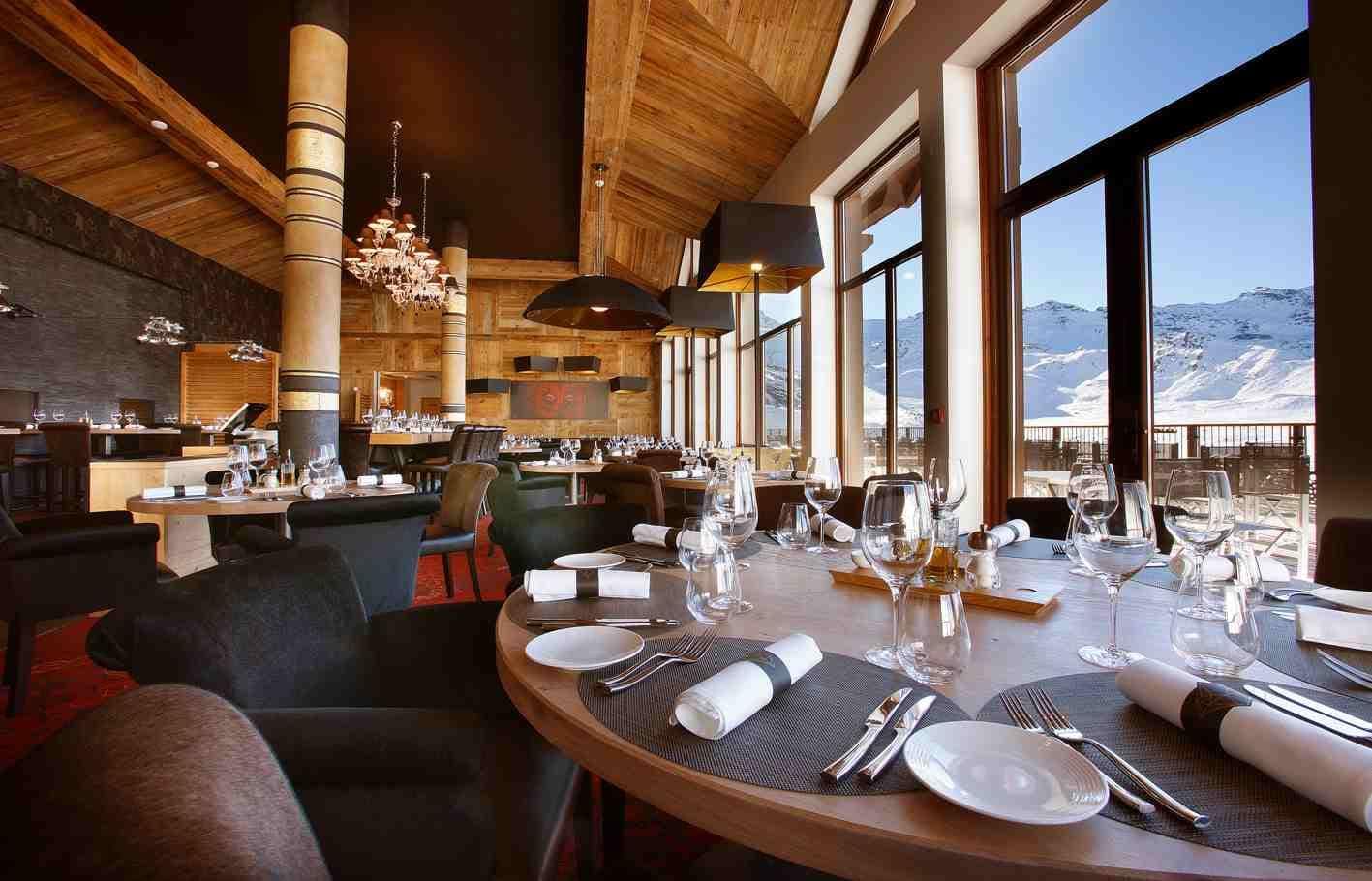 Dining area with floor-to-ceiling windows and panoramic mountain views