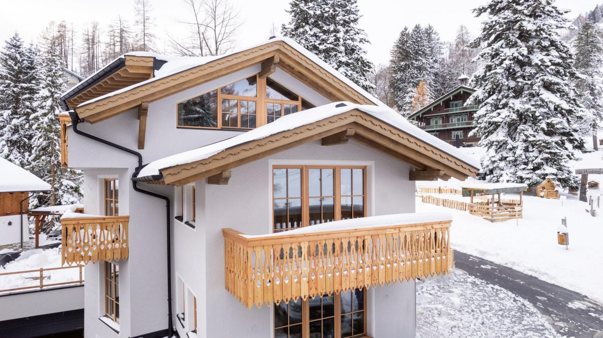 Chalet exterior with multiple private balconies and carved woodwork