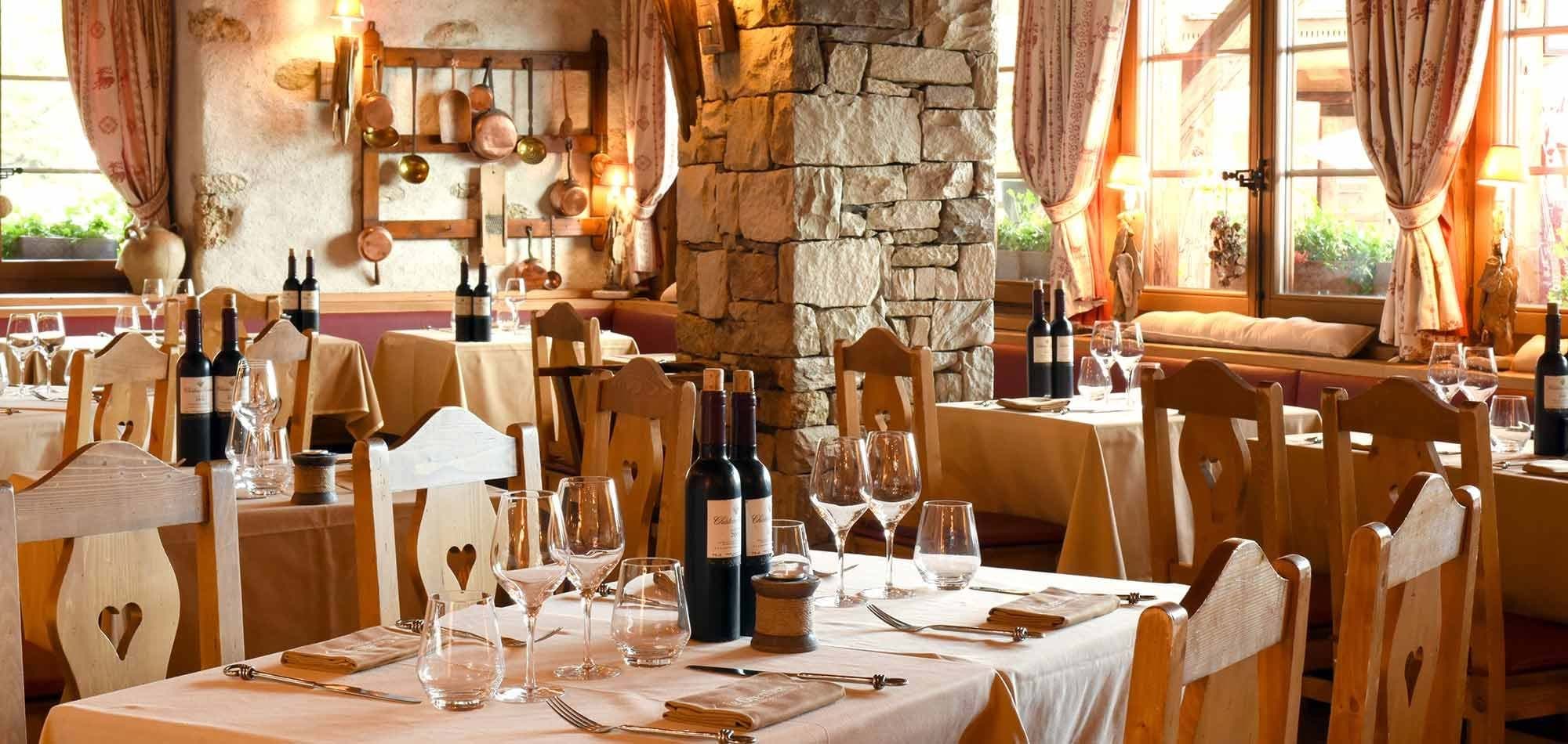 Dining room with heart-carved wood chairs and copper cookware display