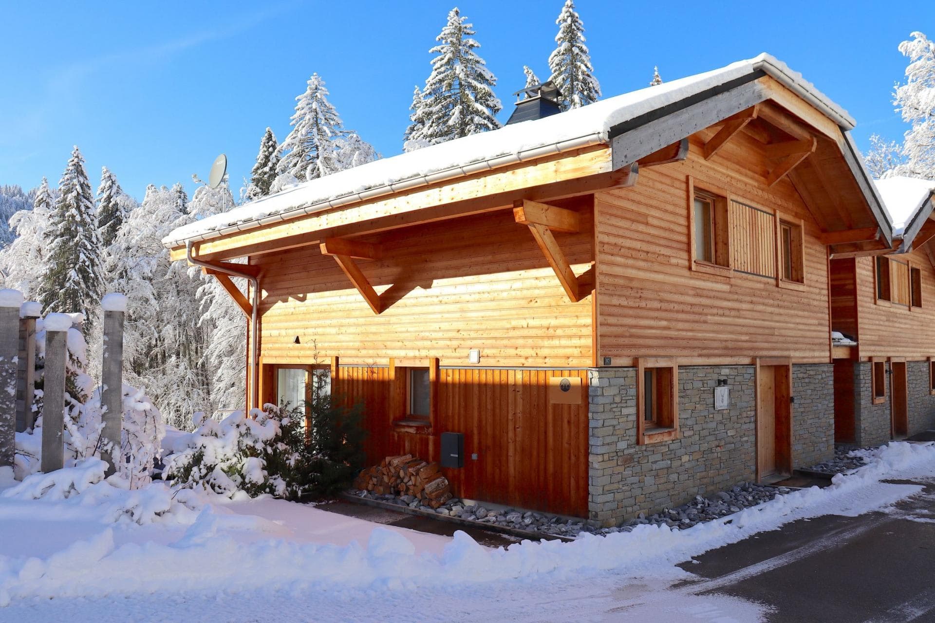 Ski-in chalet with timber facade and stone-clad lower level