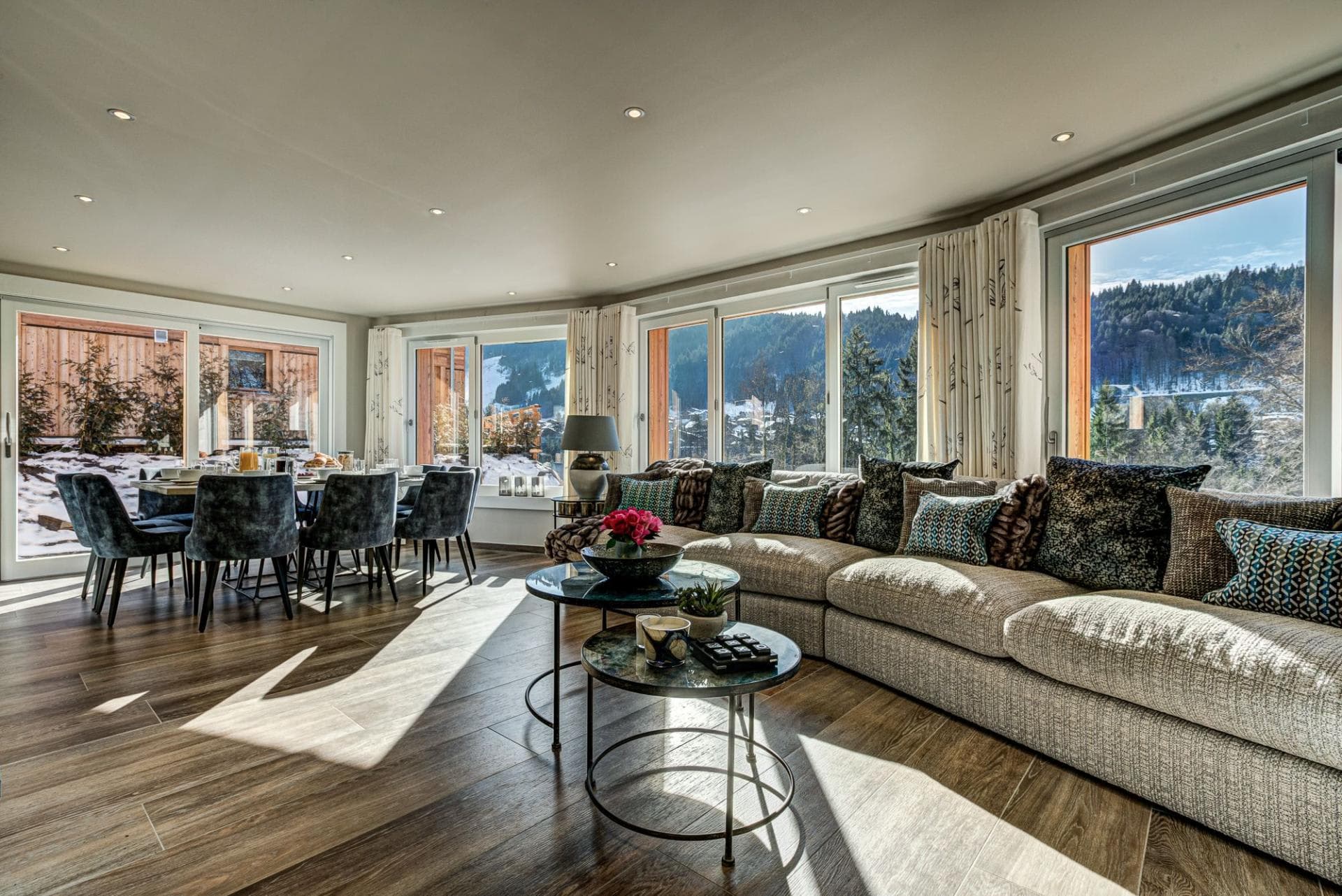 Open-plan living area with forest views and dining for 8