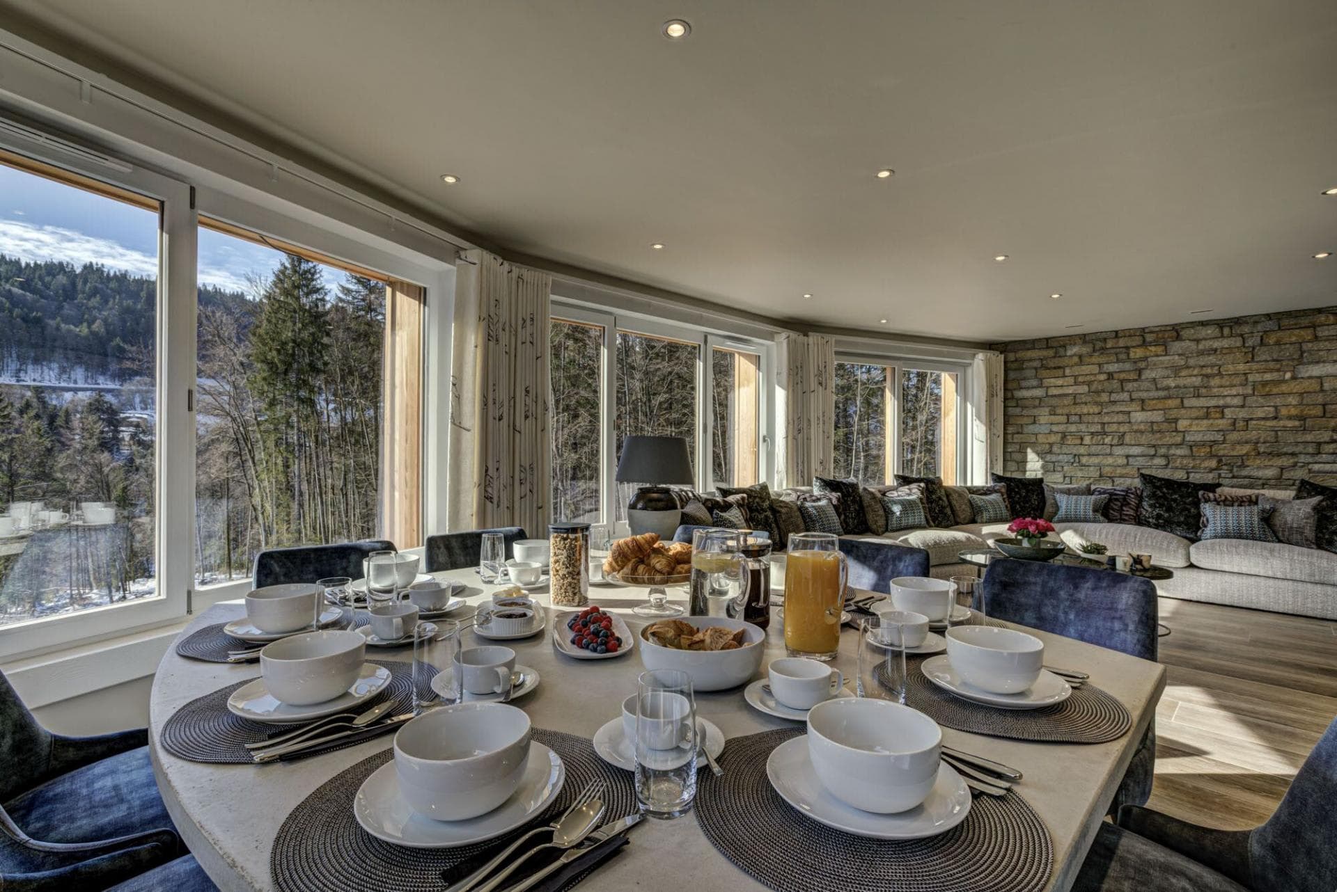Open-plan dining area with forest views and seating for 10