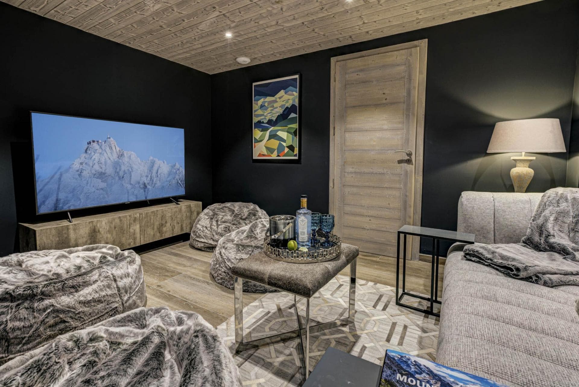 Media room with large smart TV and faux-fur bean bag seating