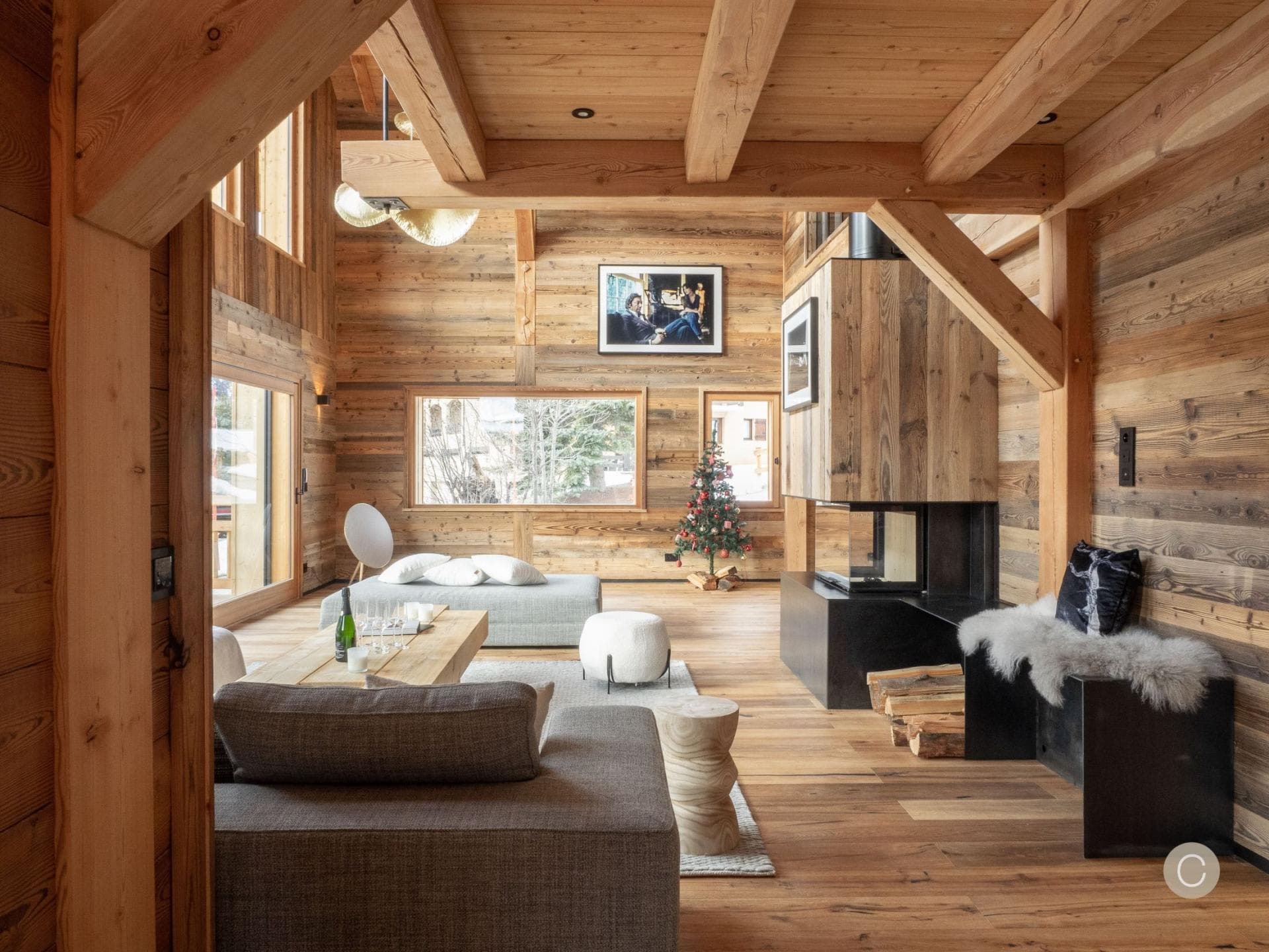 Living room with wood-burning fireplace and exposed timber beams