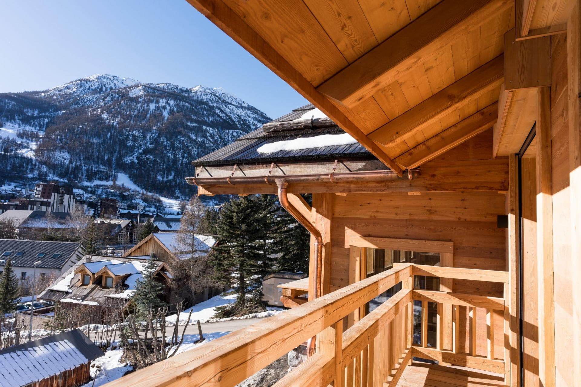 Covered balcony with mountain and ski slope views