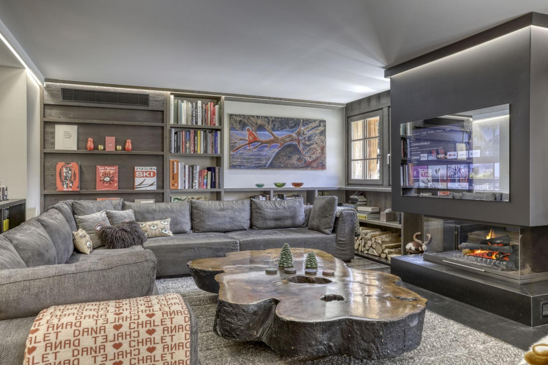 Media room with wood-burning fireplace, Smart TV, and large sectional seating