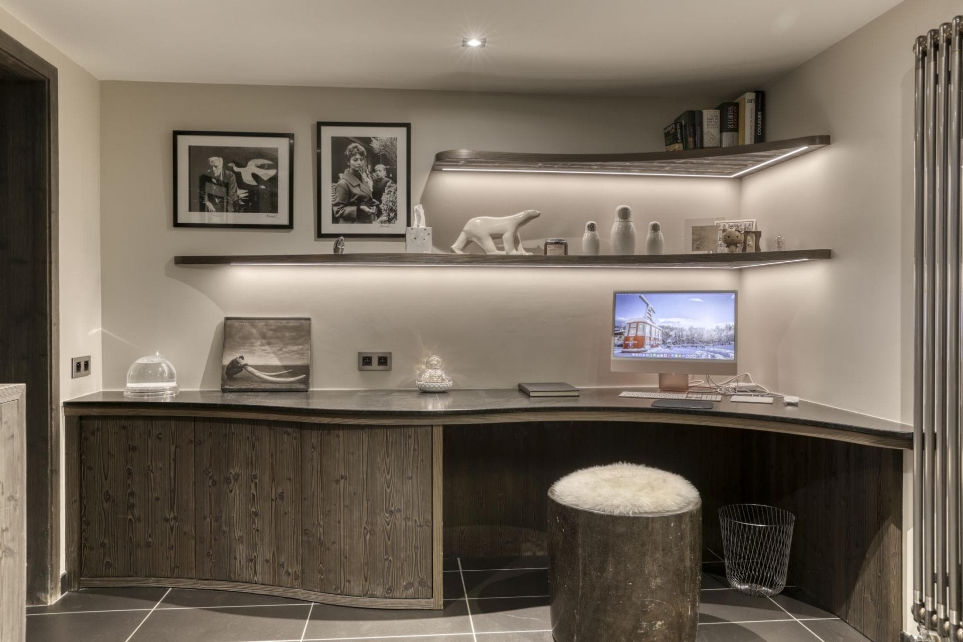 Home office nook with desktop computer and integrated LED shelving