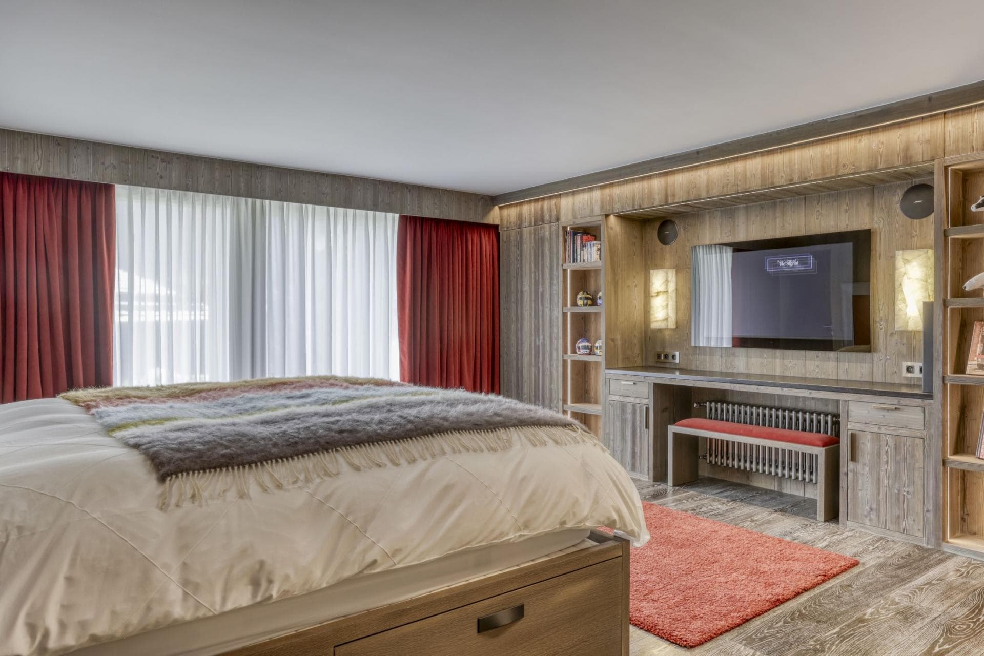 Bedroom with built-in desk, Smart TV, and under-bed storage drawer
