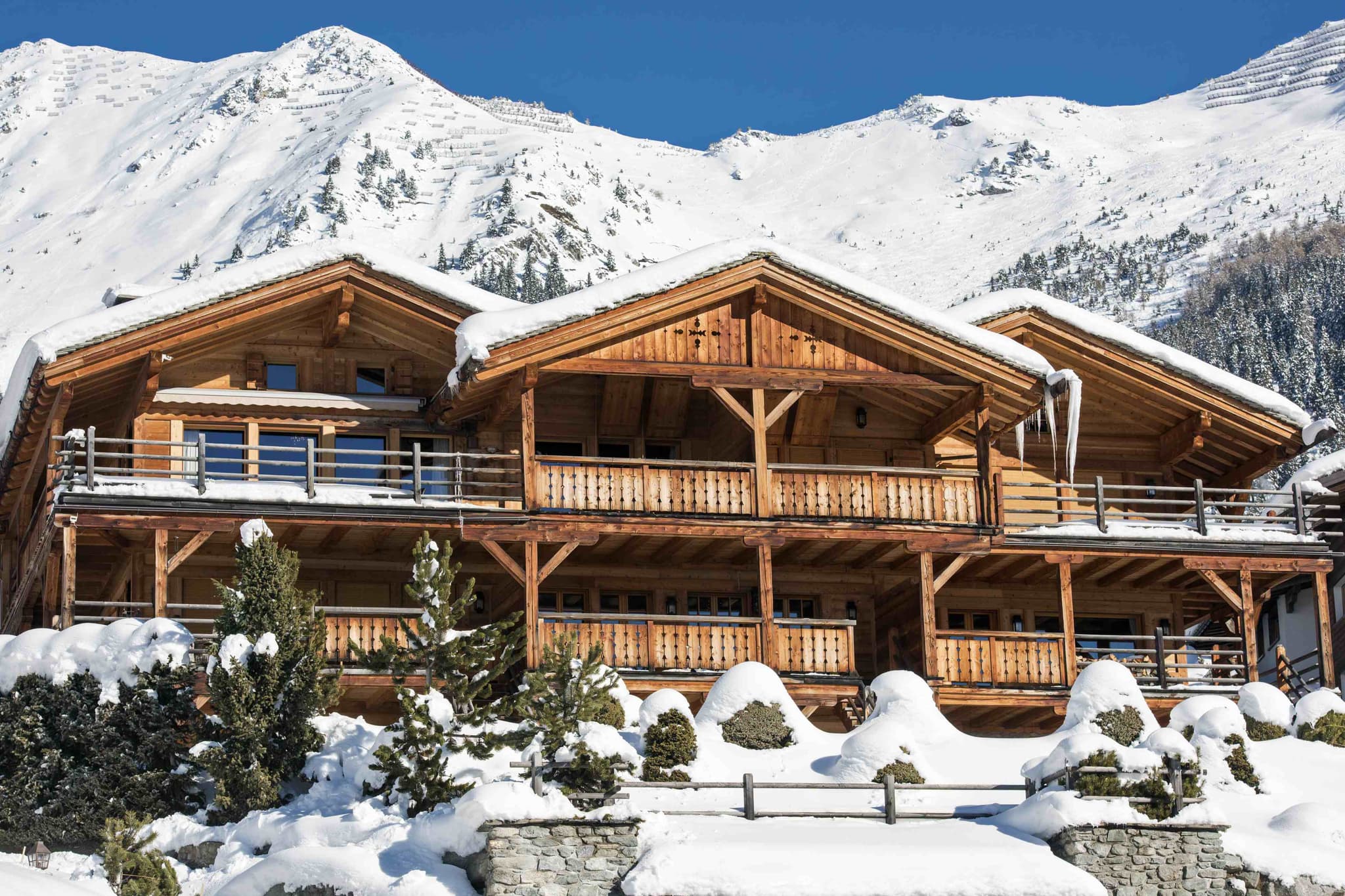 Ski-in, ski-out timber chalet with wrap-around balconies and mountain views