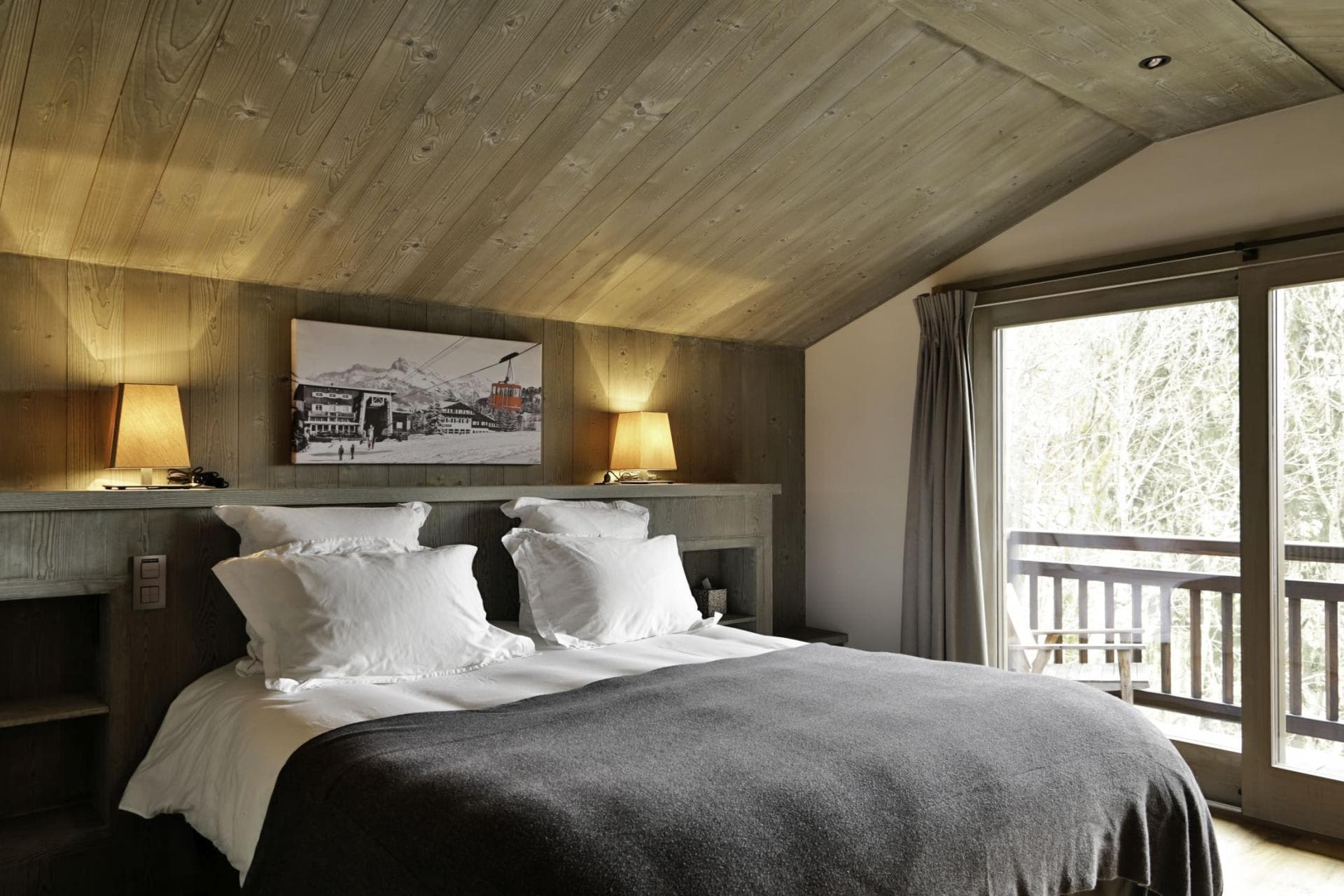 Guest bedroom with balcony access and integrated bedside shelving