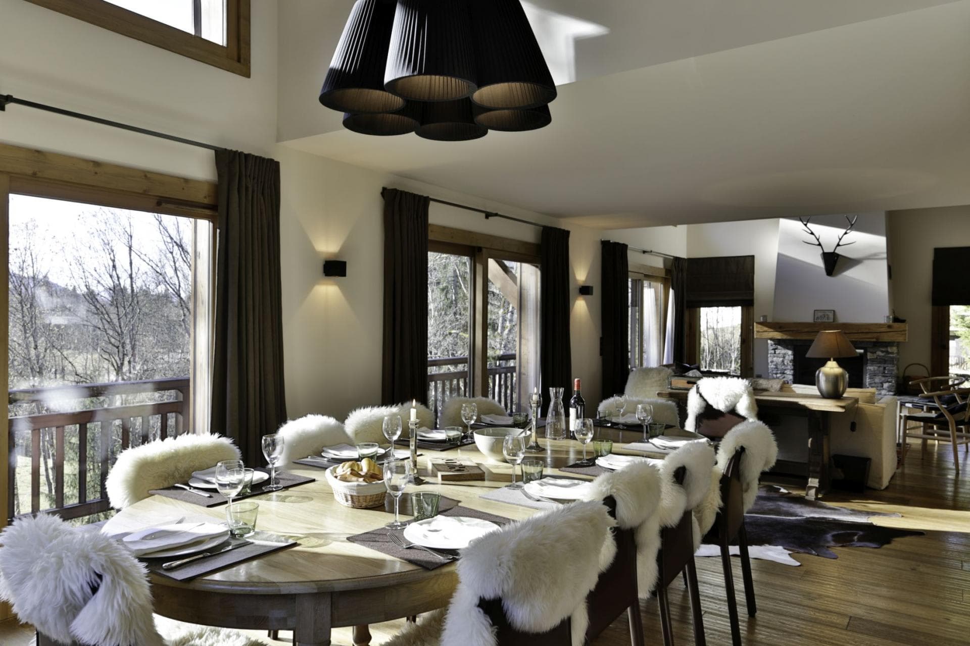 Dining area seating 10 with balcony access and fireplace view