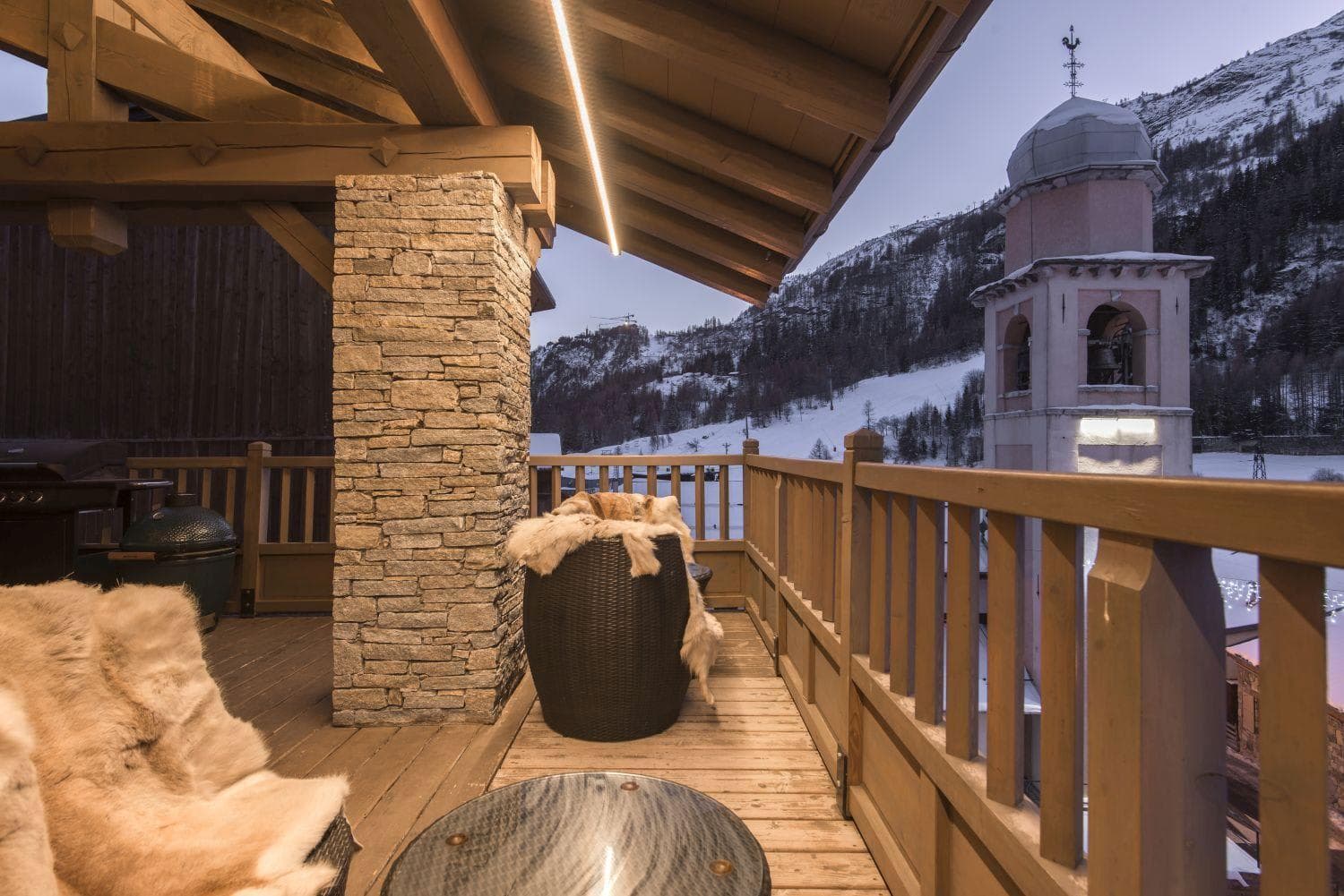 Covered balcony with Big Green Egg grill and village church views