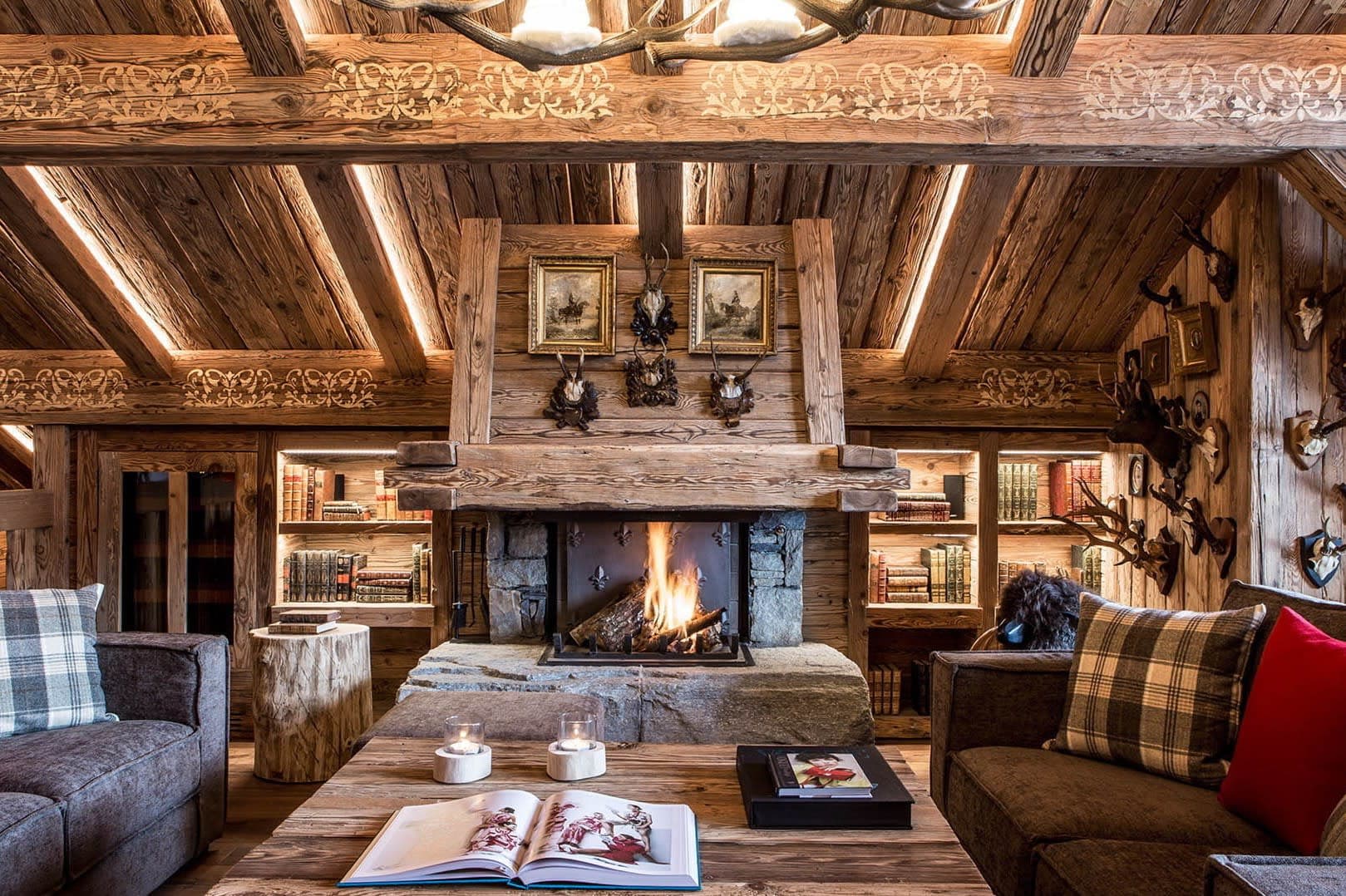 Wood-burning fireplace with stone hearth and built-in library shelving