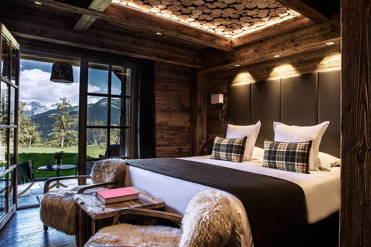 Primary bedroom with king bed and private terrace access to mountain views