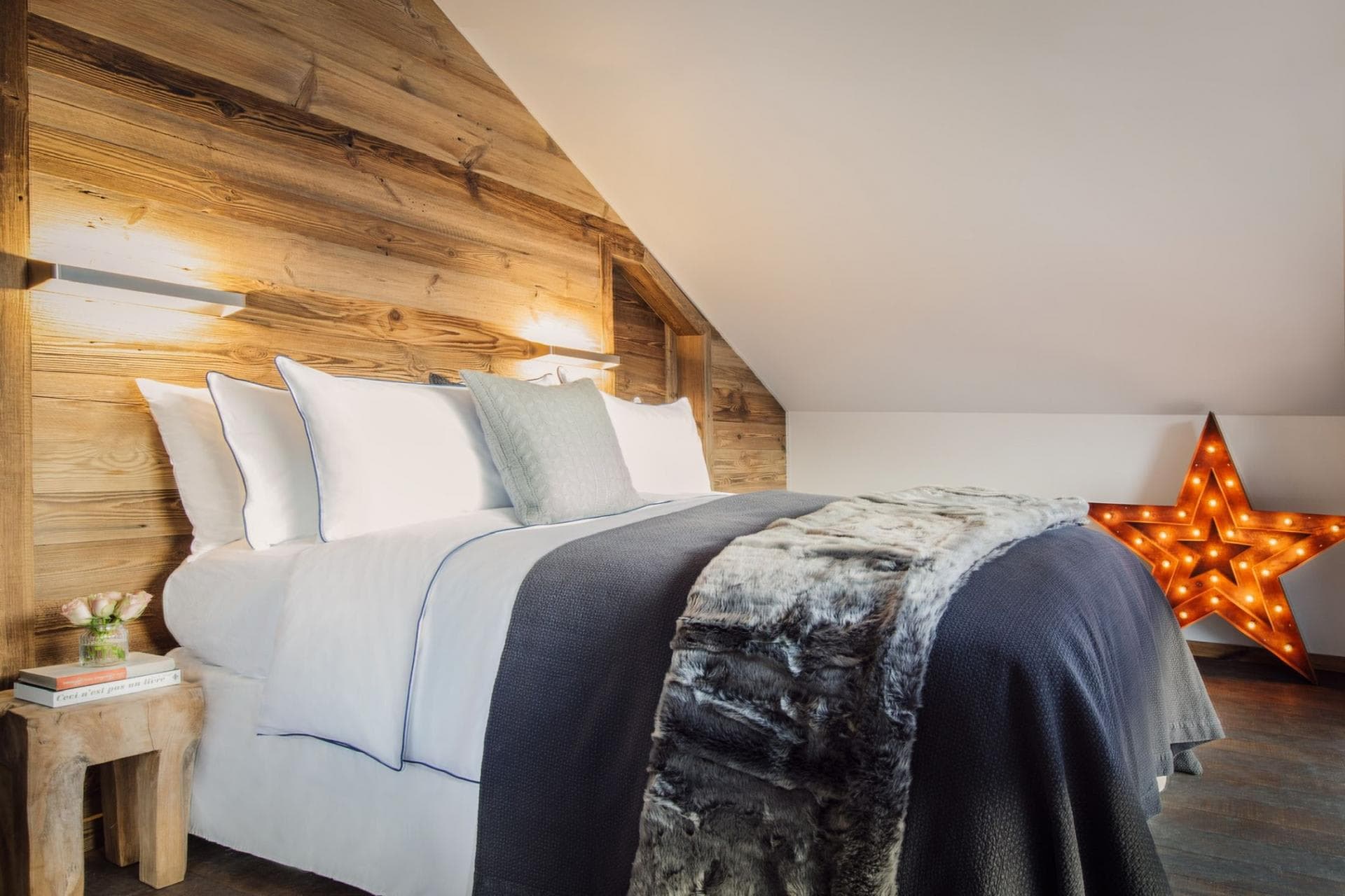 Attic bedroom with king bed and reclaimed wood accent wall