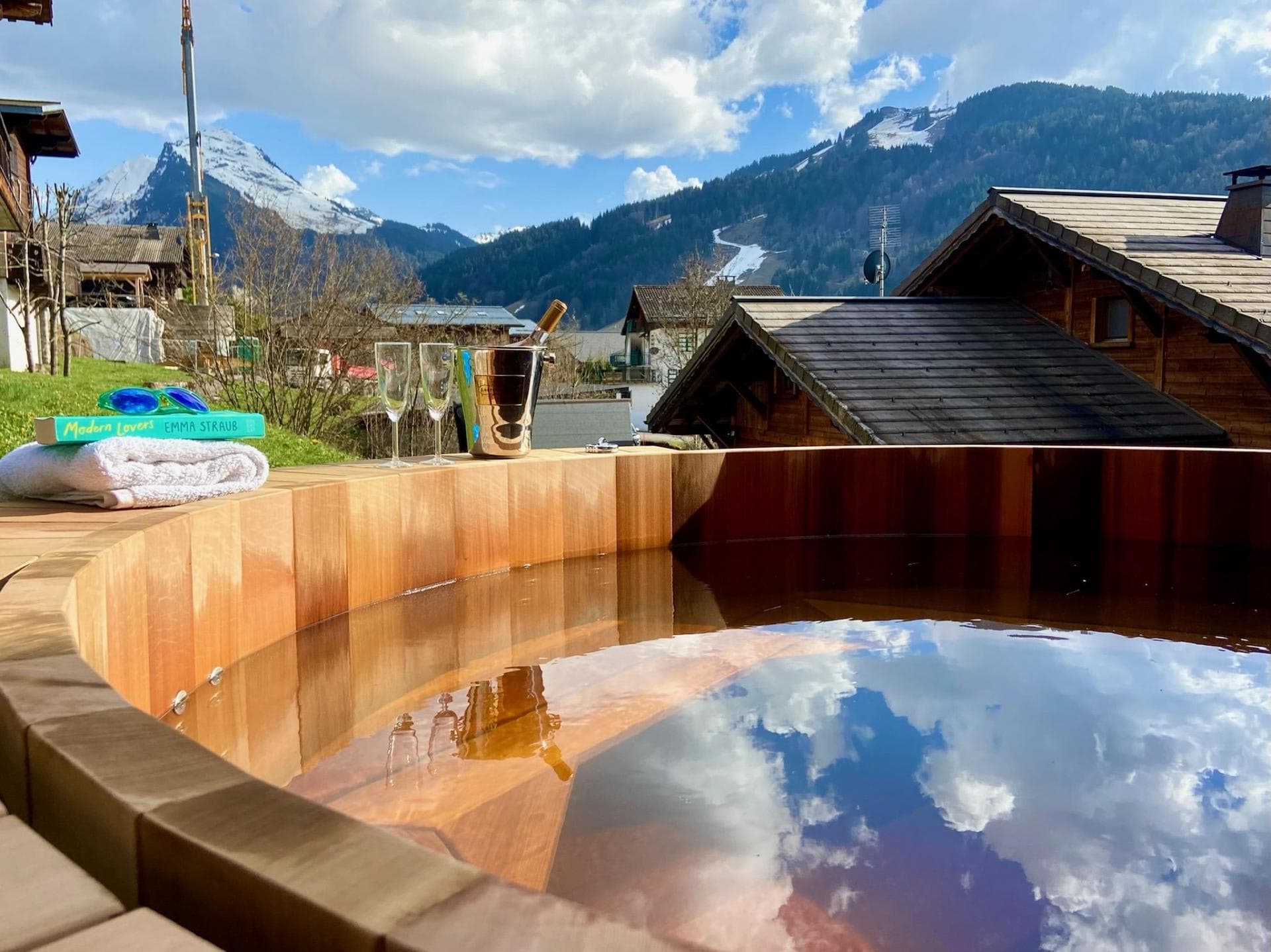 Cedar hot tub with internal bench seating and alpine valley views