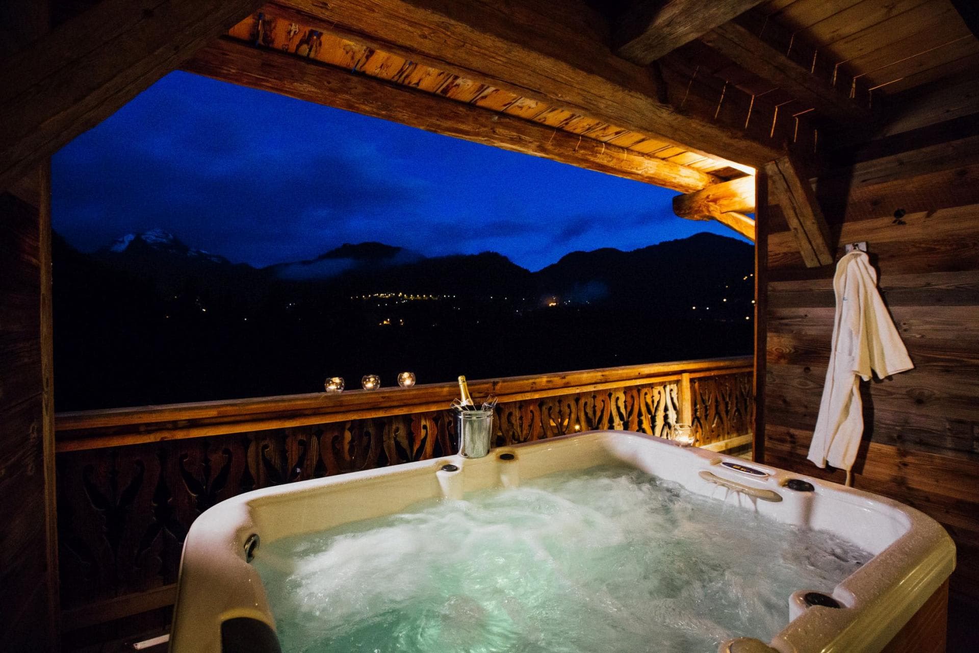 Covered balcony hot tub with panoramic mountain views
