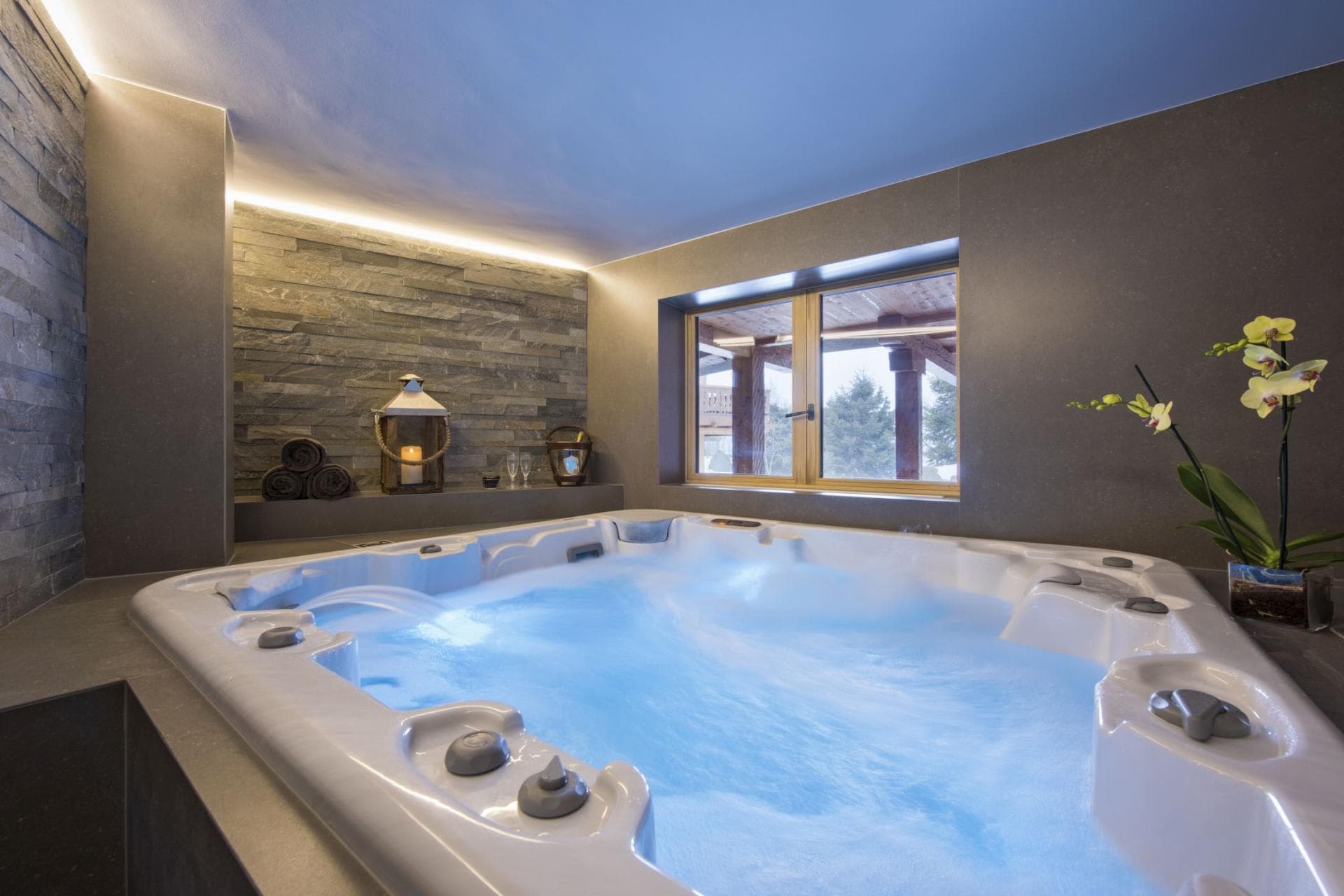 Indoor hot tub seats 6; features stone walls and terrace views